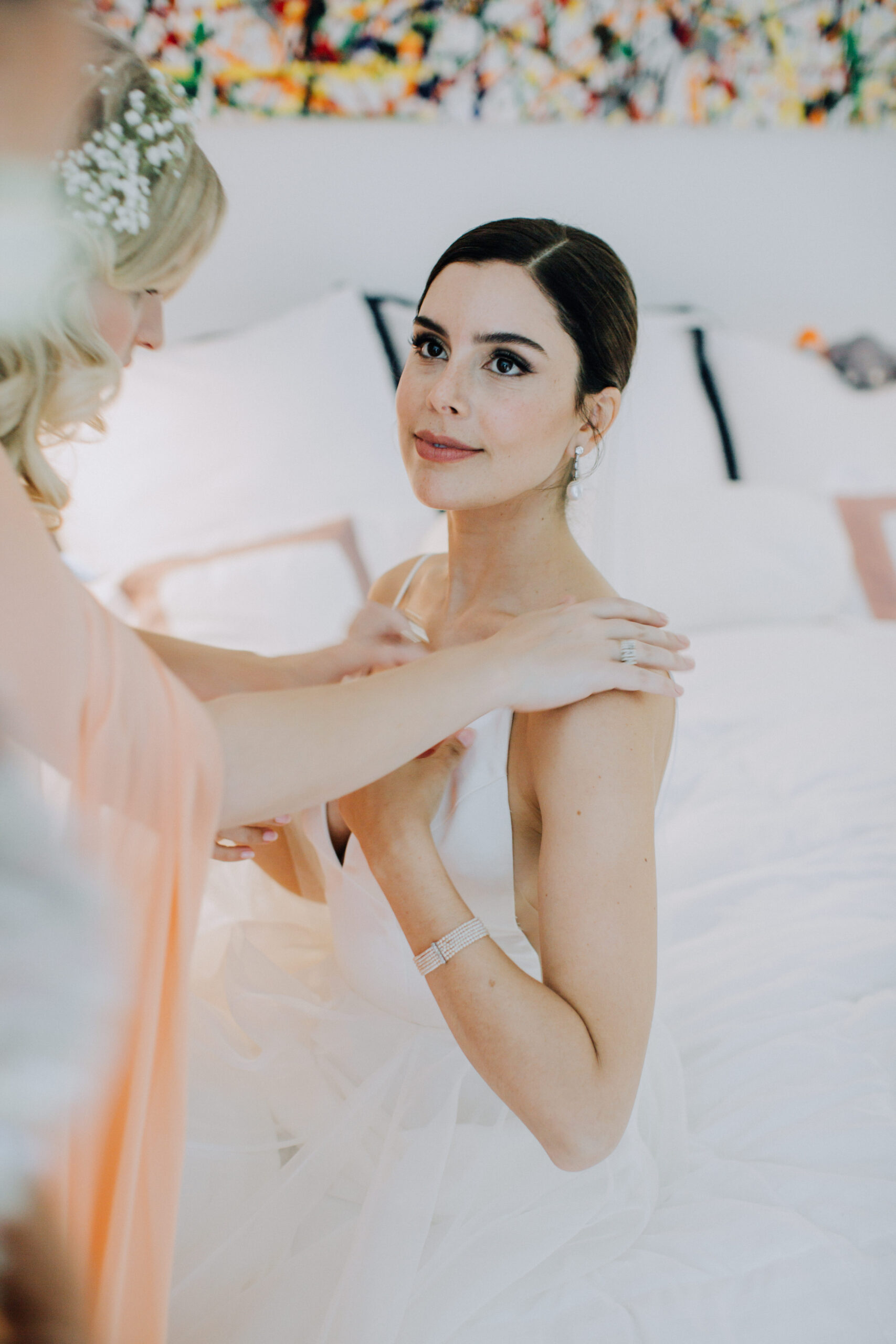 bride gets help to finish her prep before her dreamy Los Angeles wedding day 