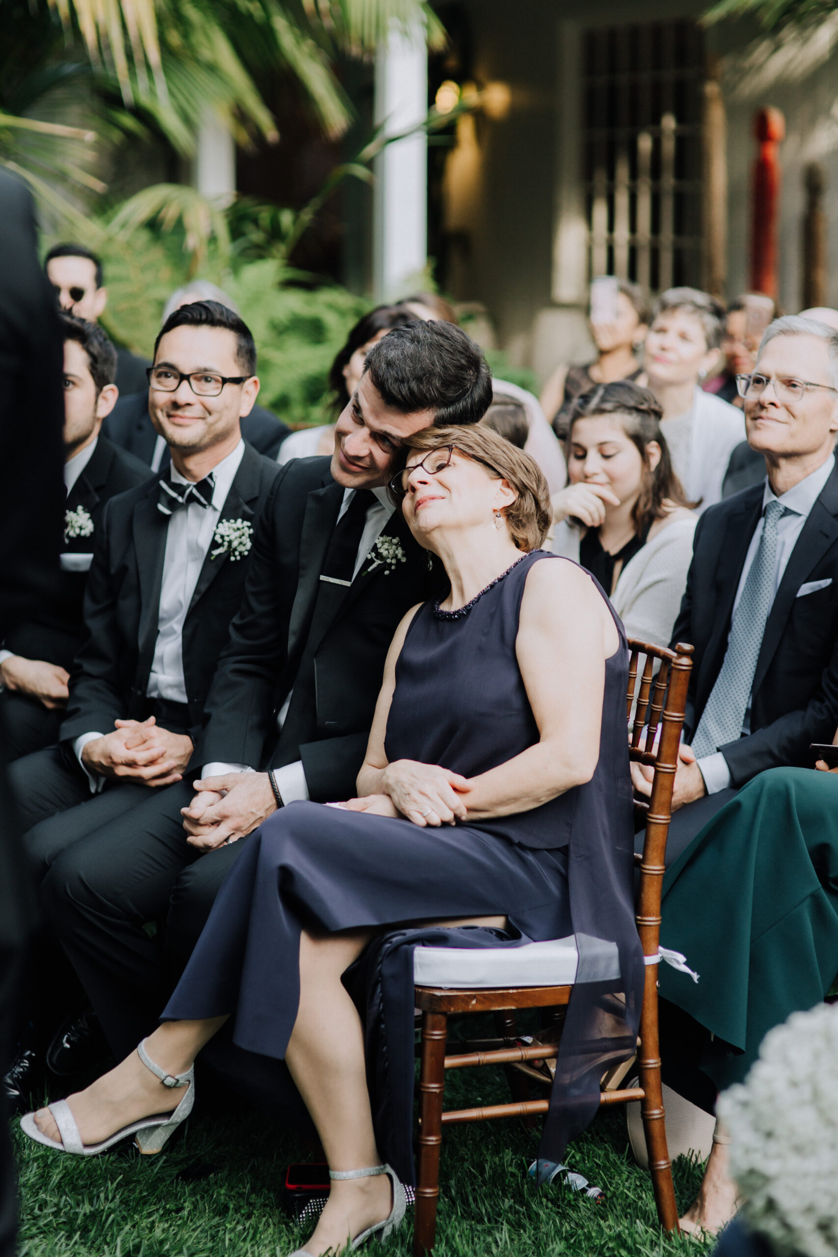 guests look on during the dreamy backyard wedding ceremony 