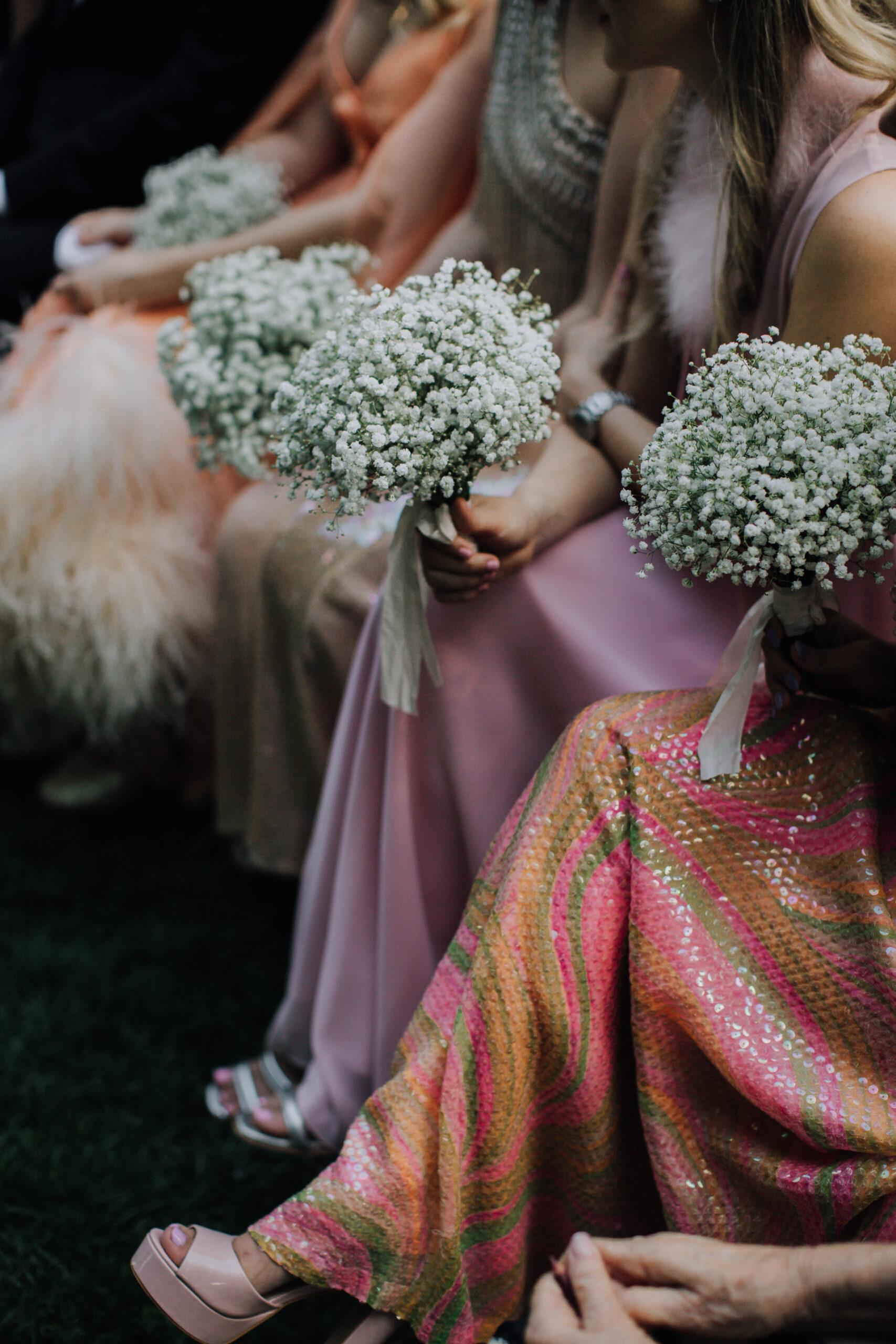 bridesmaids hold their bouquets during the dreamy garden wedding ceremony 