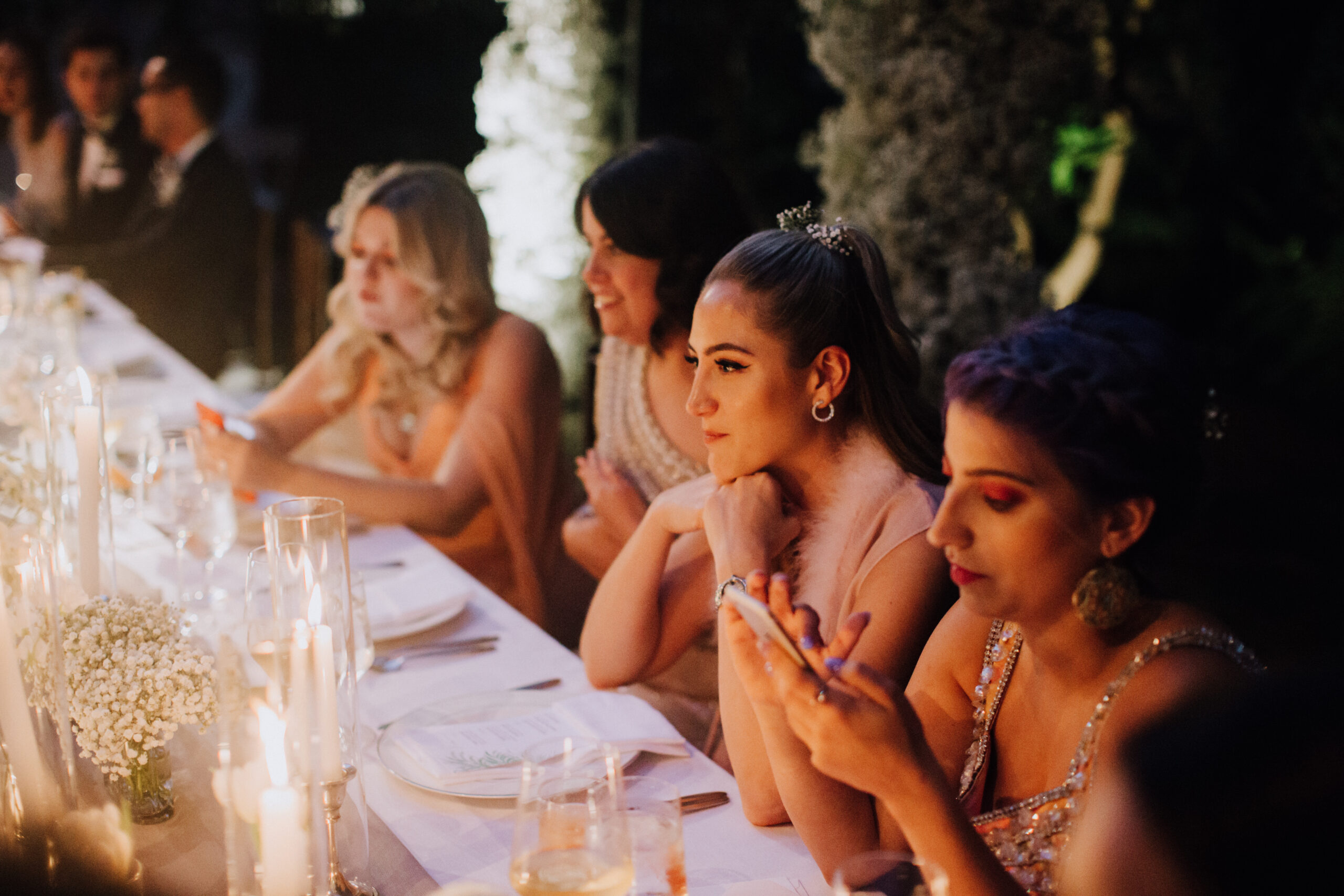 bridesmaids look on during the wedding reception 