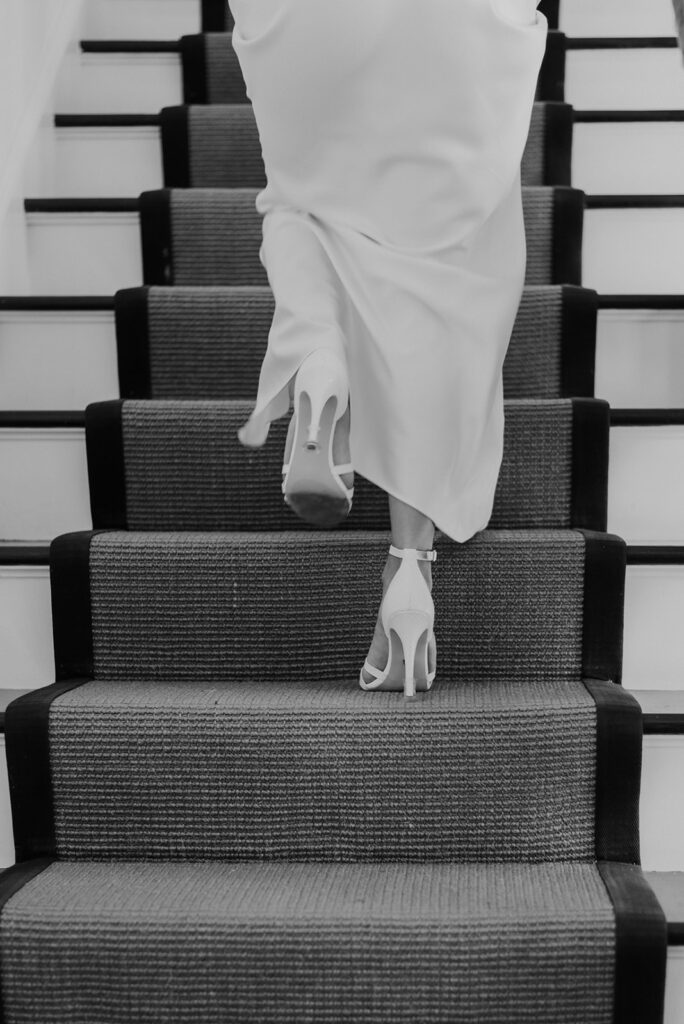 bride climbs stairs towards her reception