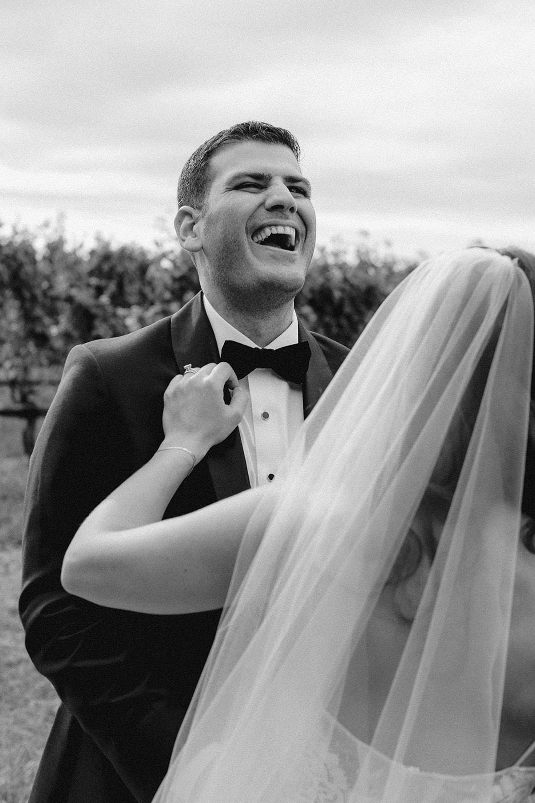 gorgeous bride and groom pose together after their vineyard wedding on long island