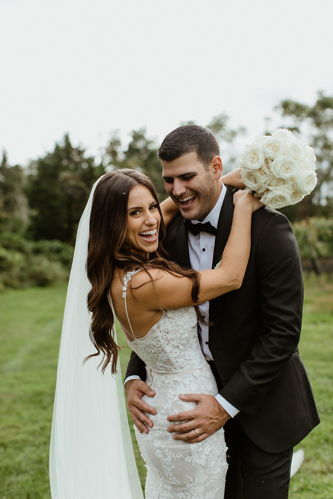 gorgeous bride and groom pose together after their vineyard wedding on long island