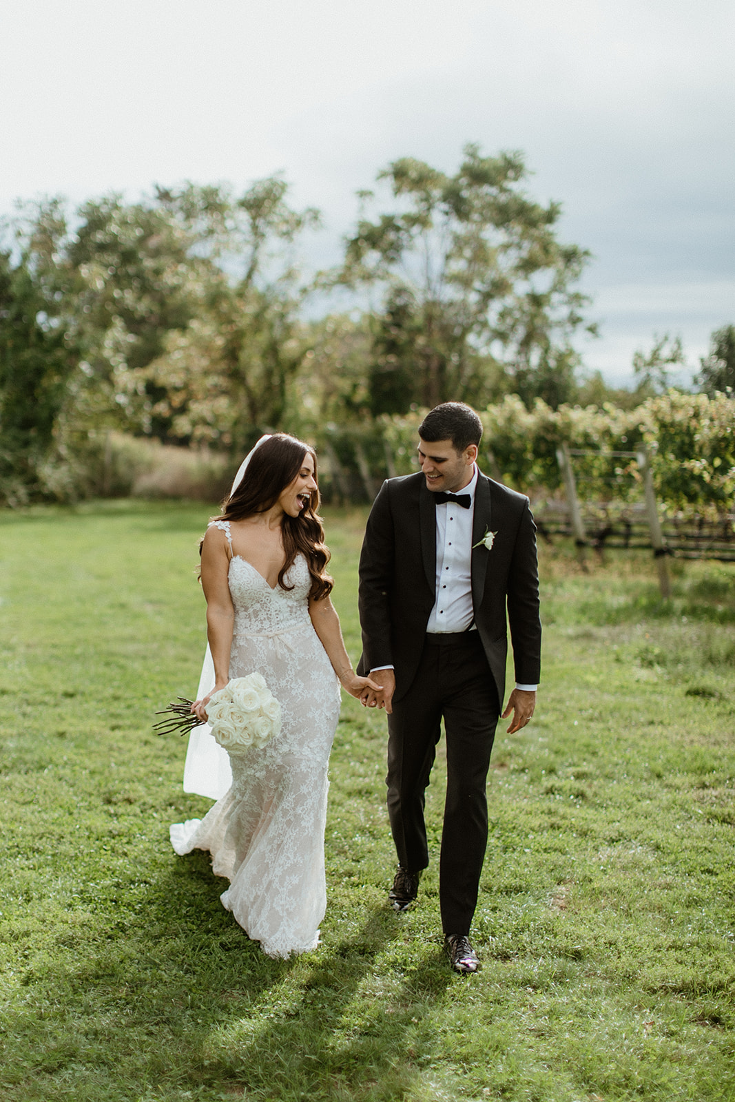 gorgeous bride and groom pose together after their vineyard wedding on long island