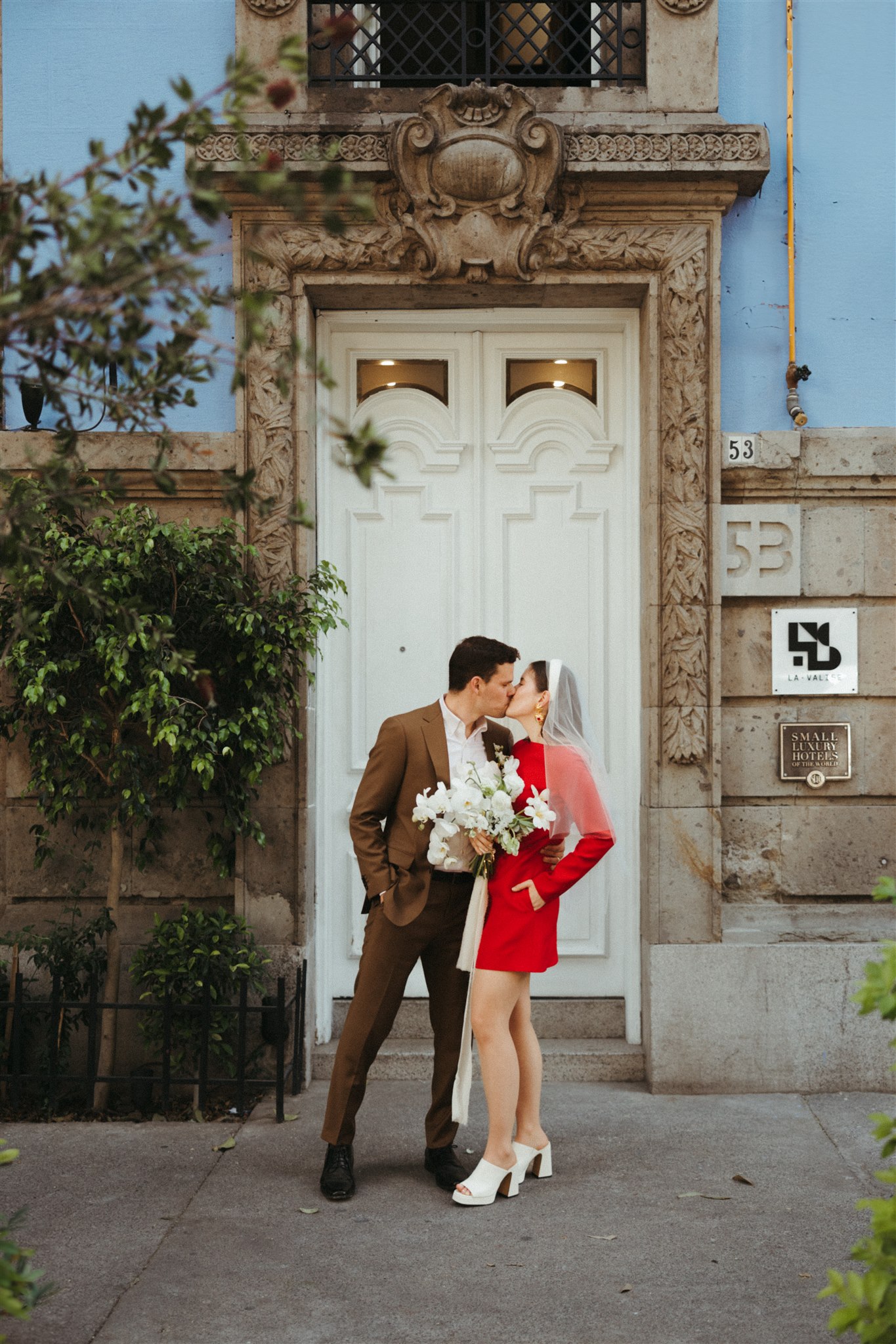 bride and groom walk the streets of Mexico City together after their dreamy elopement 