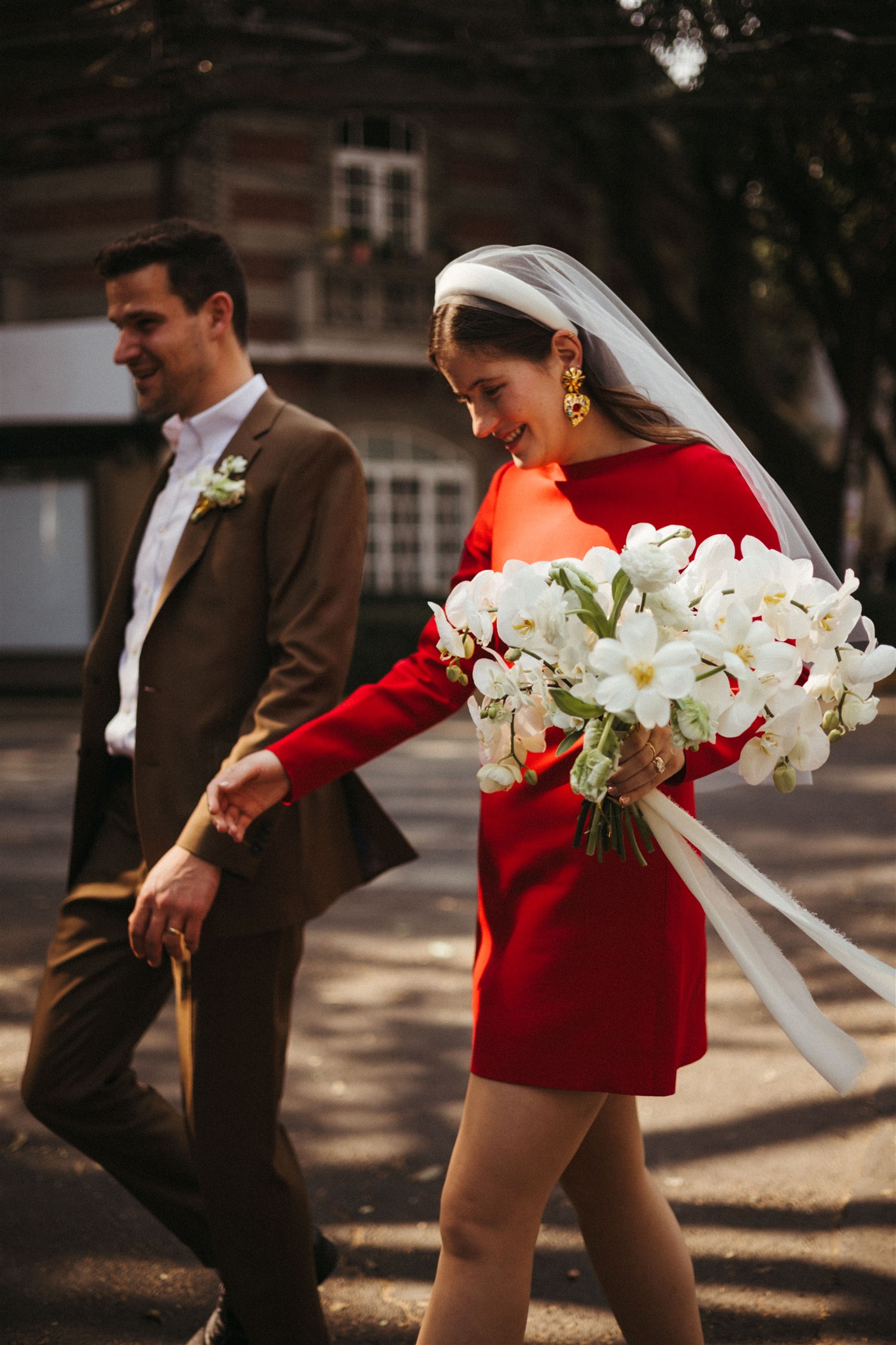 bride and groom walk the streets of Mexico City together after their dreamy elopement 