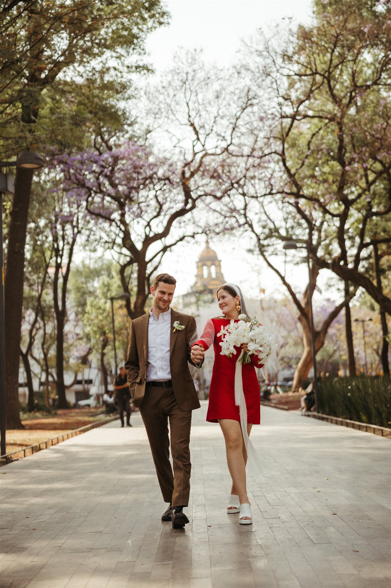 bride and groom walk the streets of Mexico City together after their dreamy elopement 