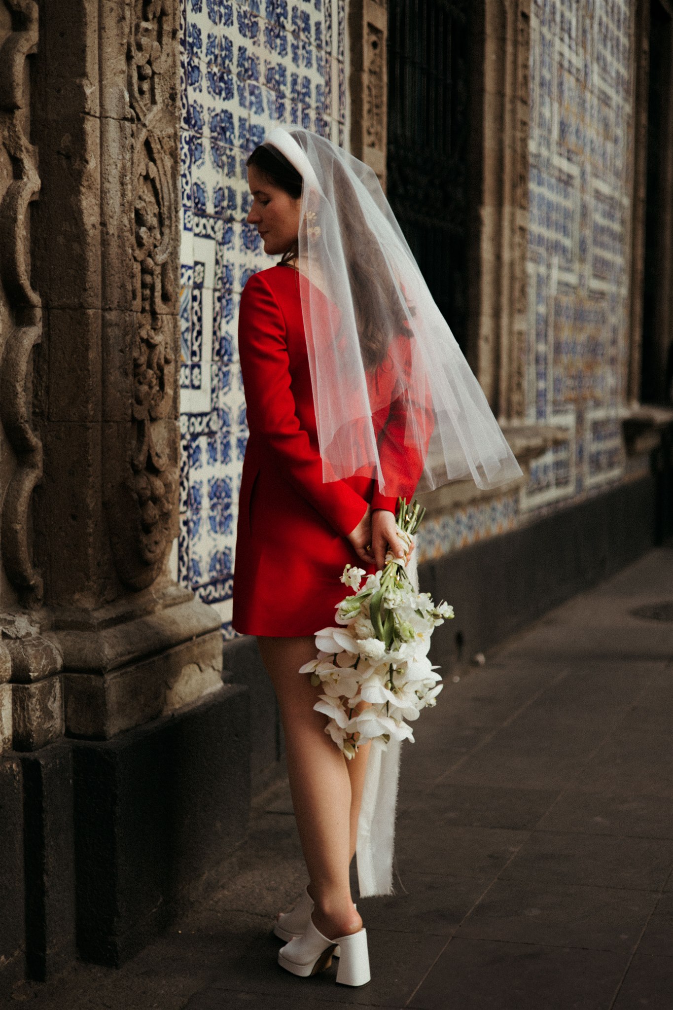 bride poses with her stunning all white bridal bouquet