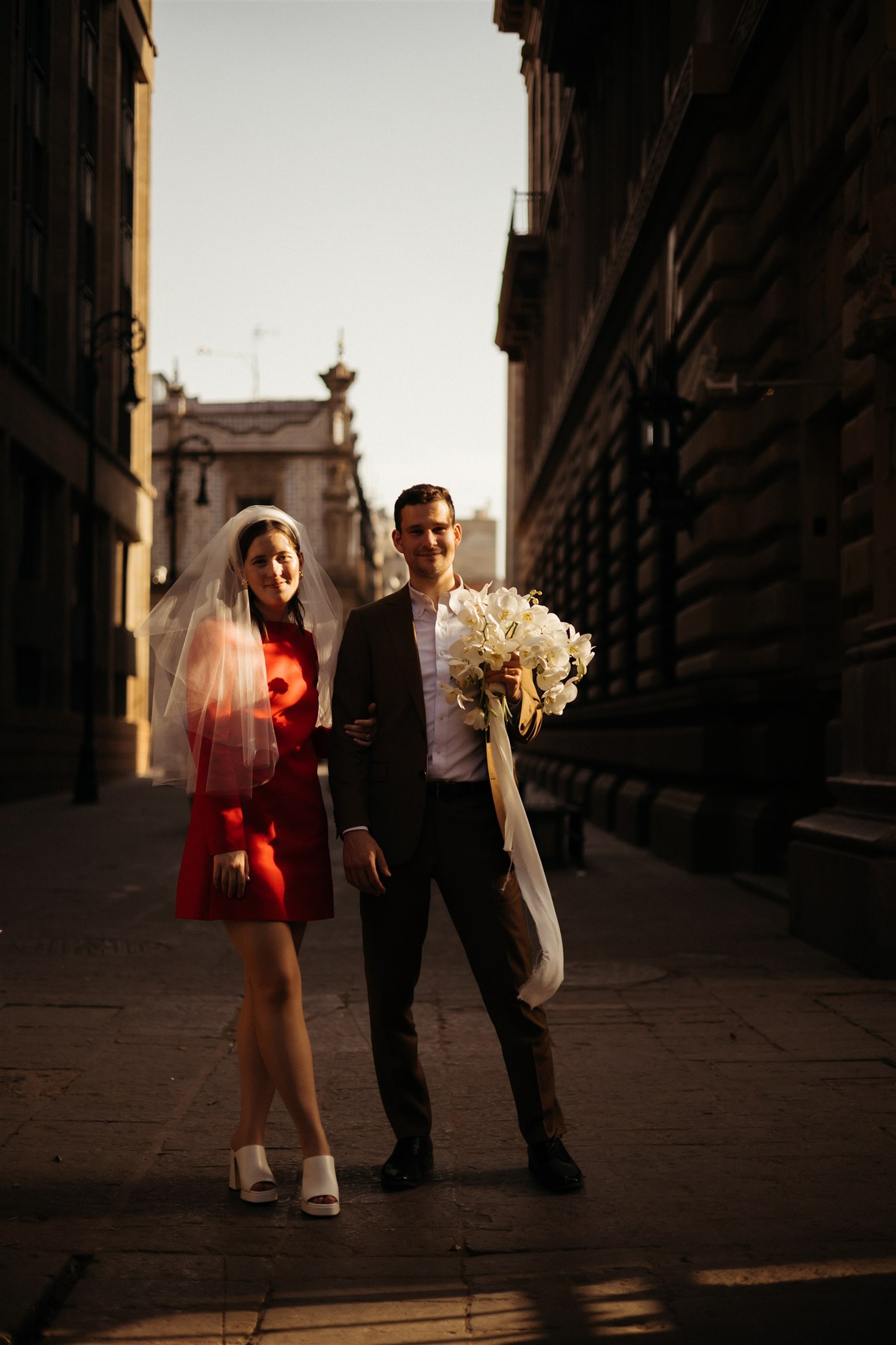 bride and groom walk the streets of Mexico City together after their dreamy elopement 