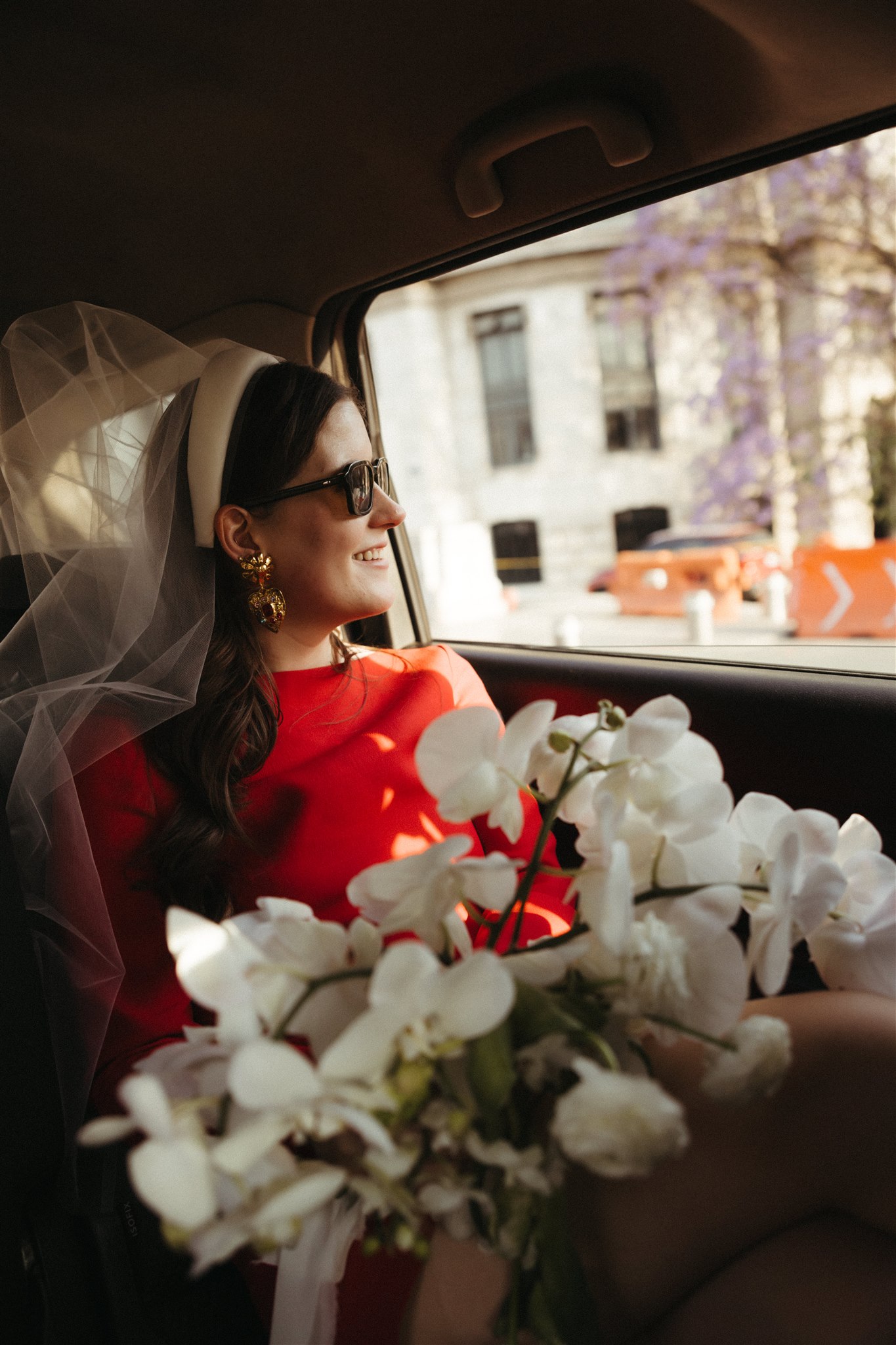 beautiful bride poses for a photo with her stunning all white bridal bouquet 