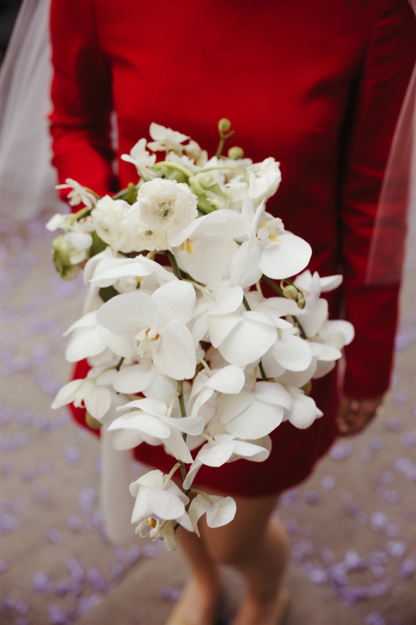 bride poses with her beautiful all white bouquet