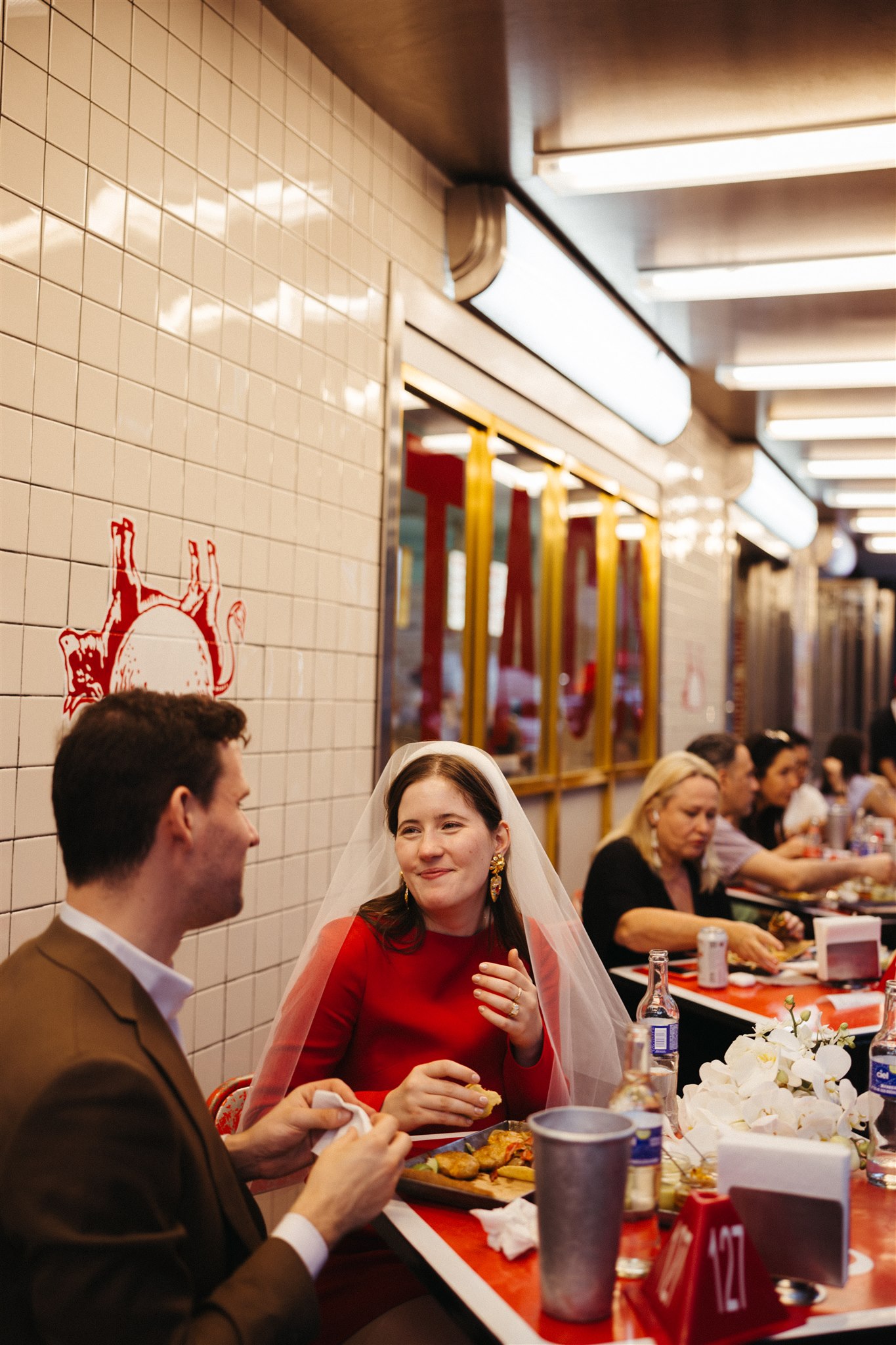 beautiful bride and groom share tacos and laughs