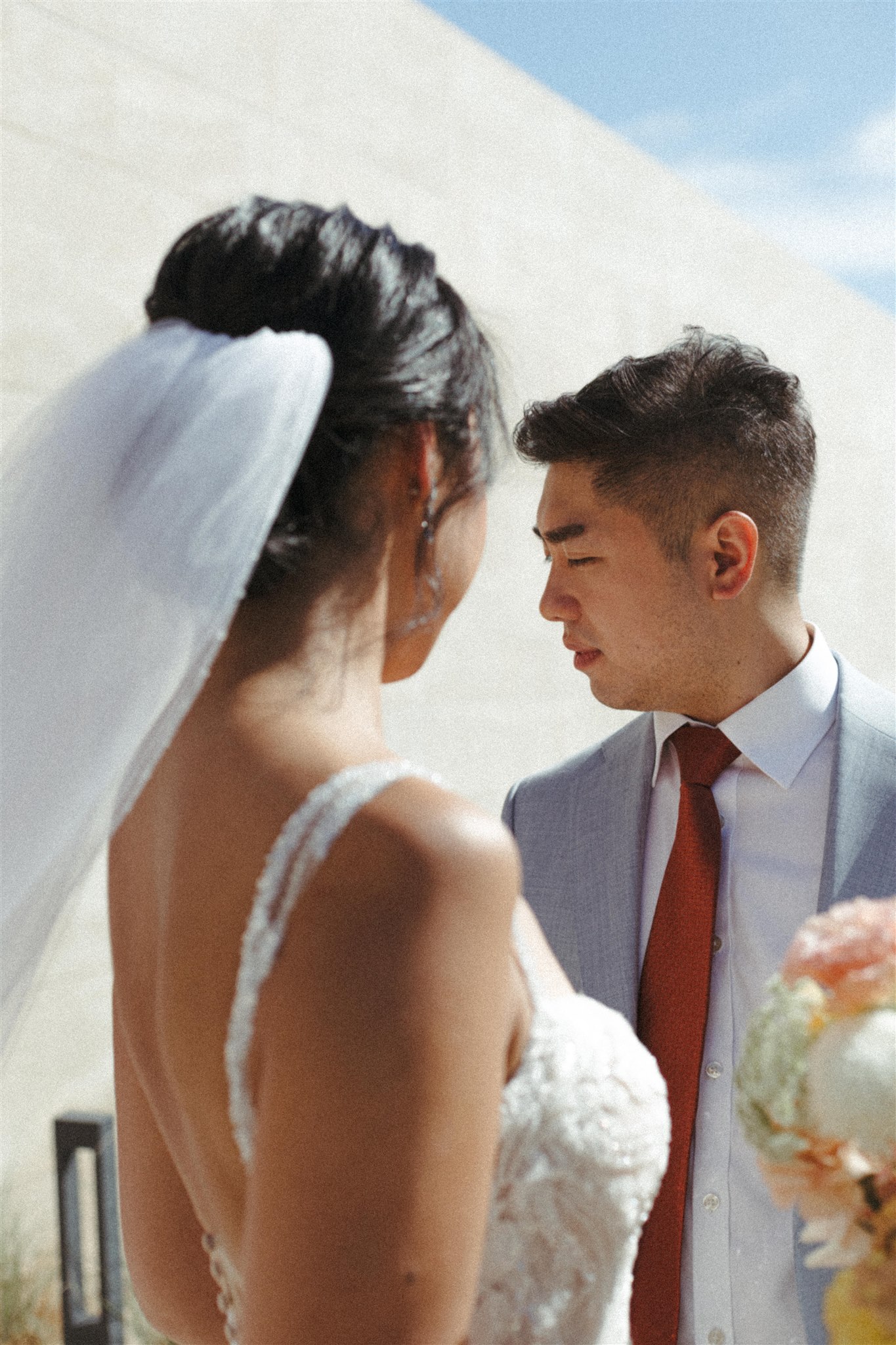 bride and groom pose together during their acre baja wedding day