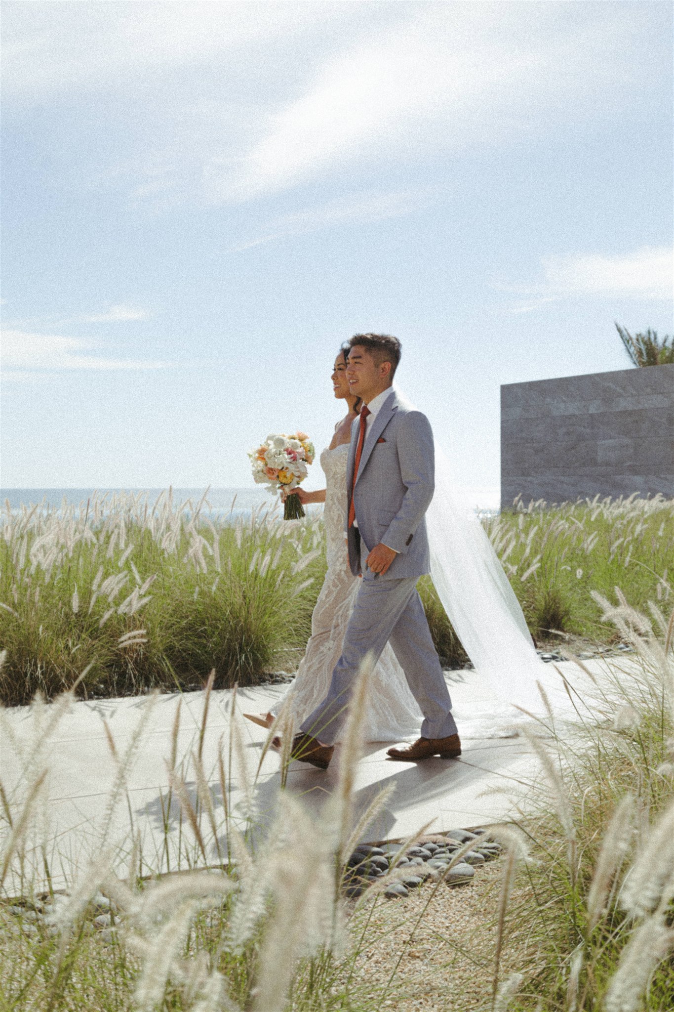 bride and groom pose together during their acre baja wedding day