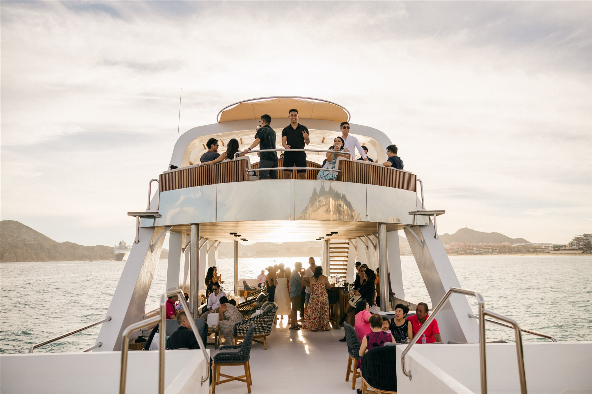 guests celebrate on a boat with the bride and groom