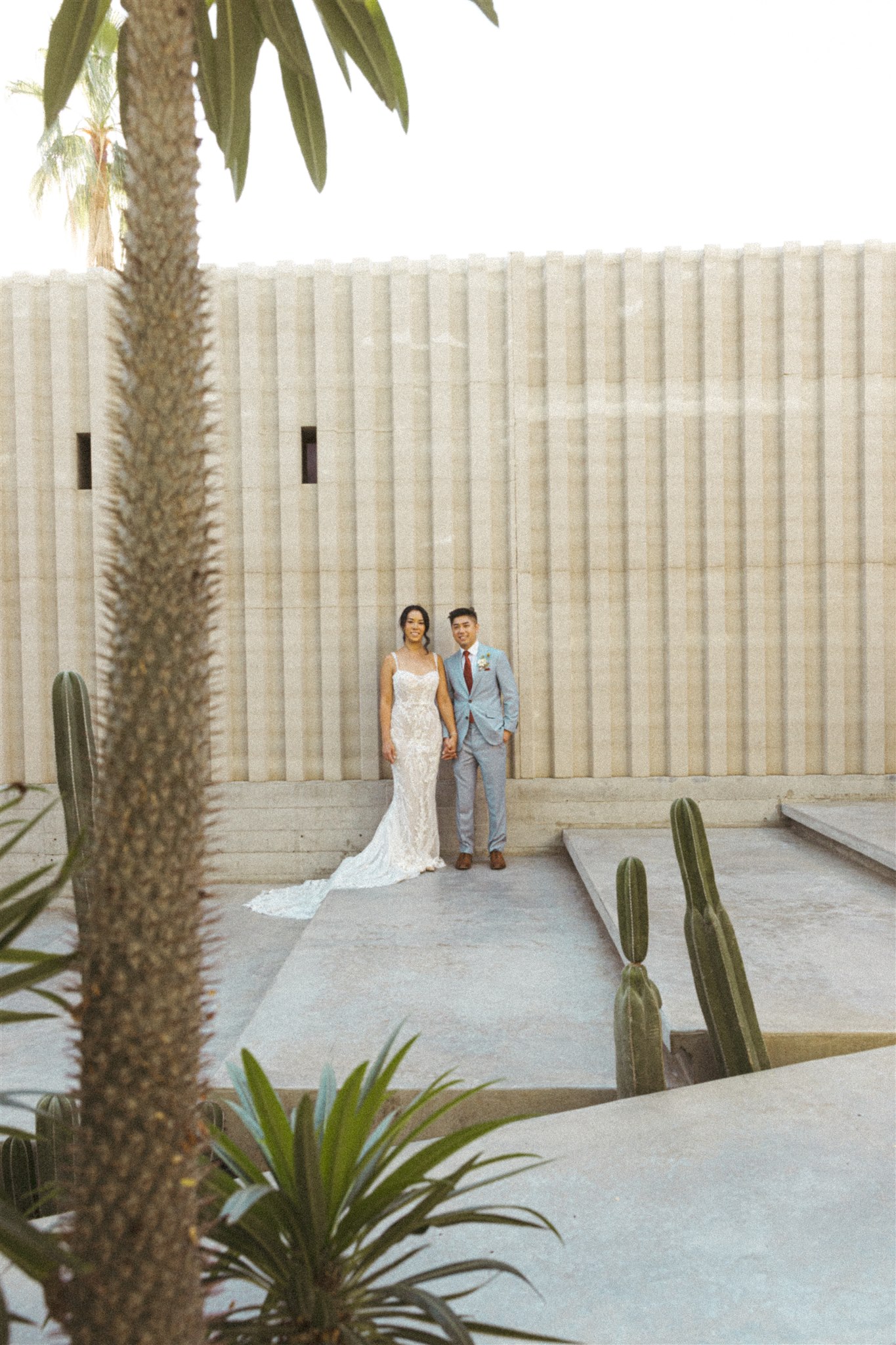 bride and groom pose together during their acre baja wedding day