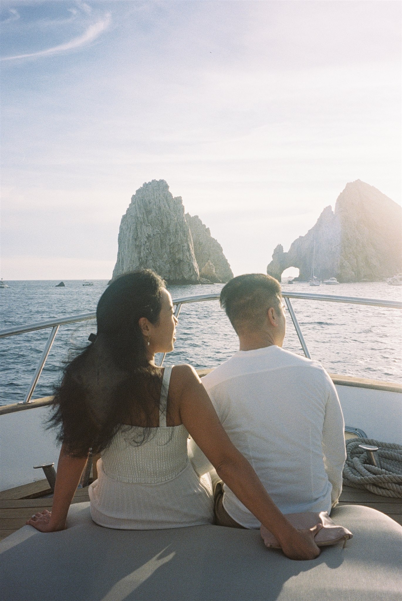 bride and groom pose together on a boat before their dreamy acre baja wedding day