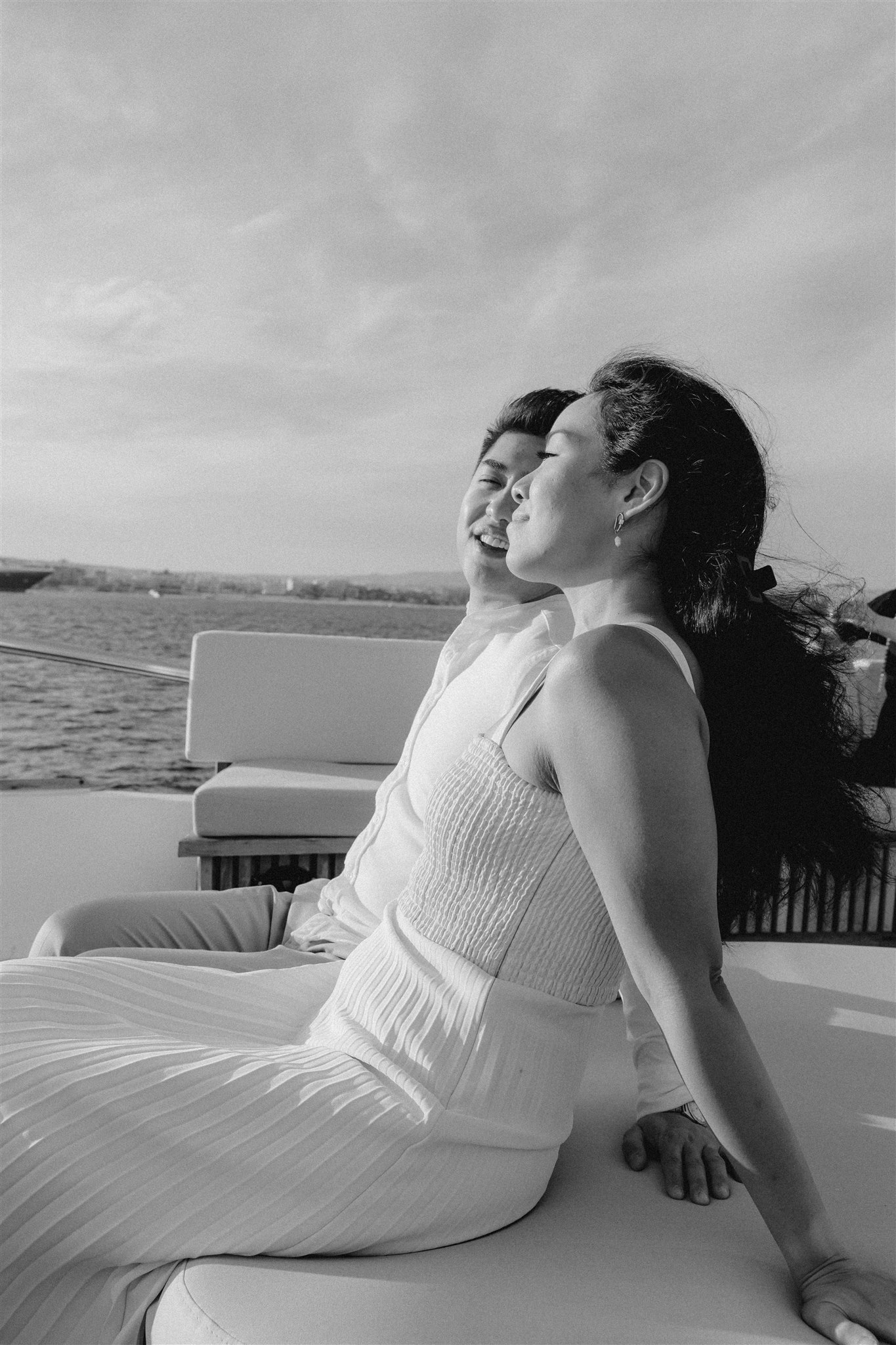 bride and groom pose on a boat together