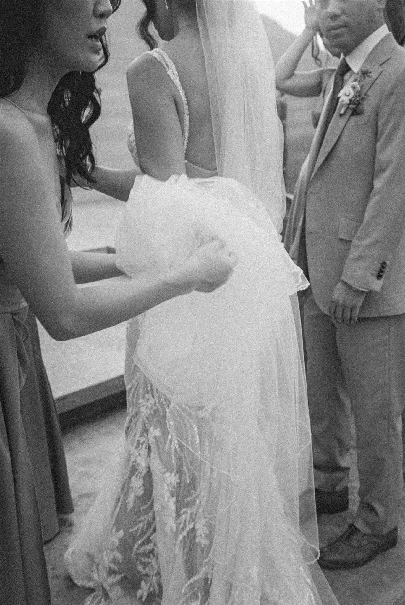 bride gets help finalizing her prep on her wedding day