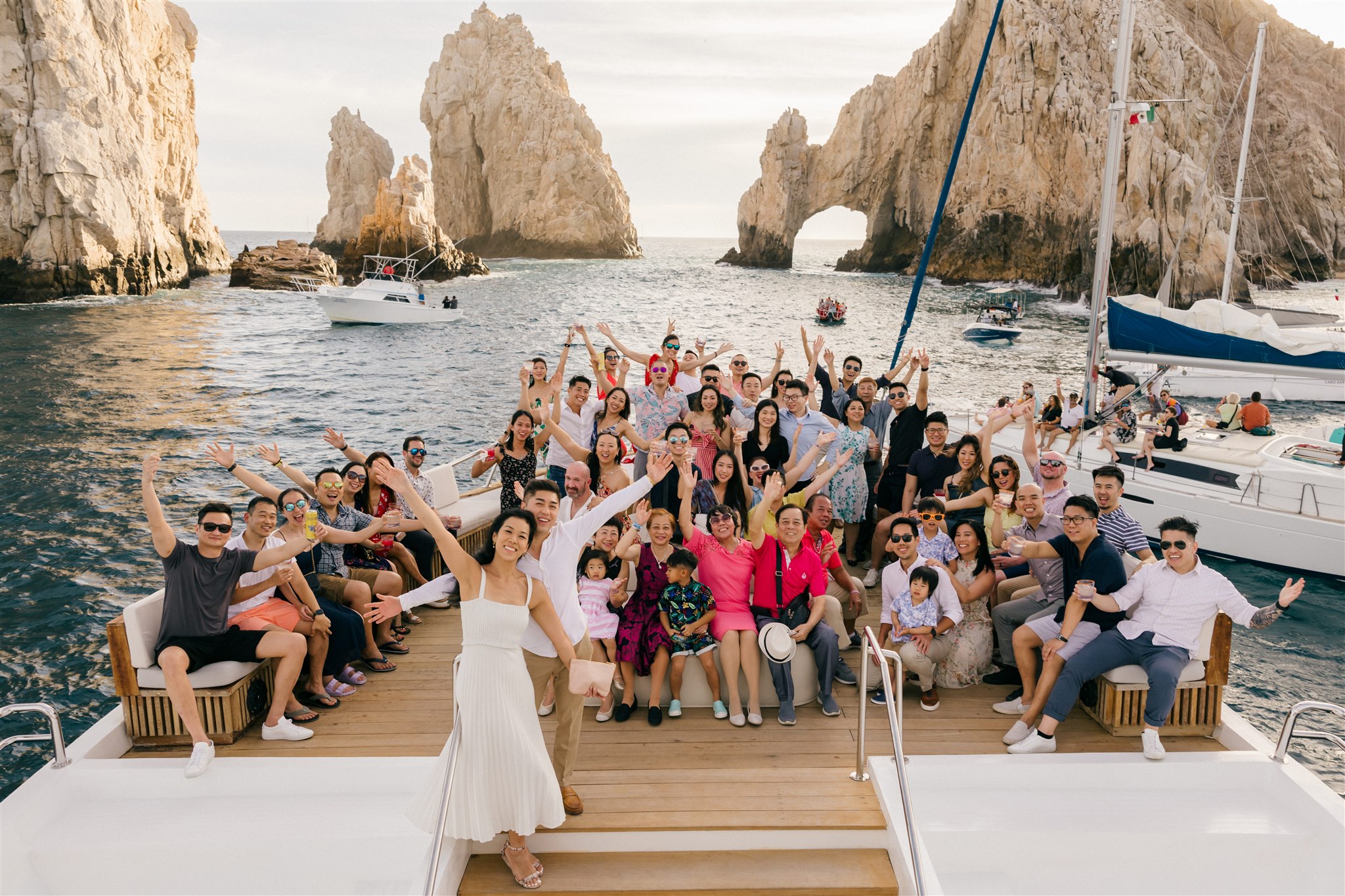 guests celebrate on a boat with the bride and groom