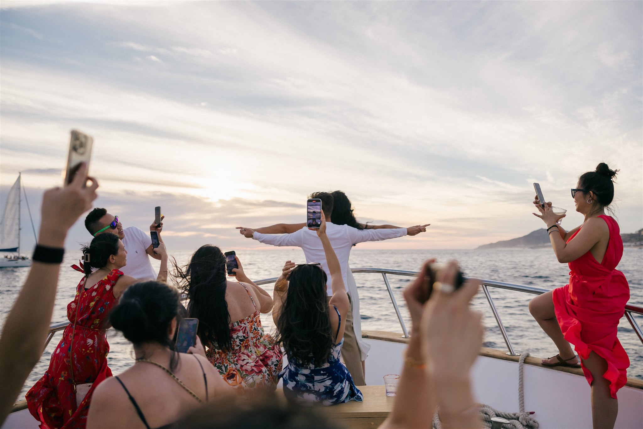 guests celebrate on a boat with the bride and groom