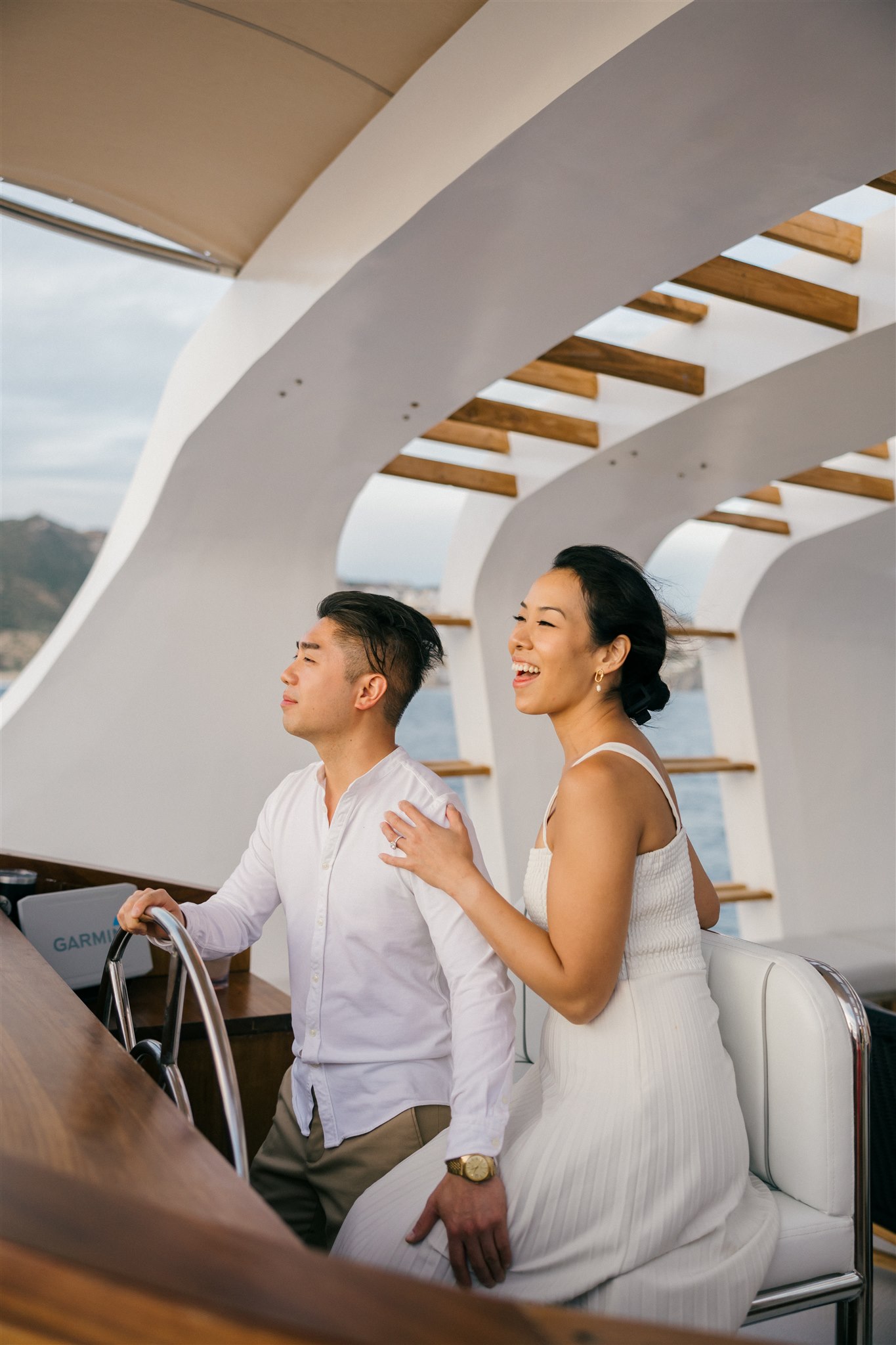 bride and groom pose on a boat together