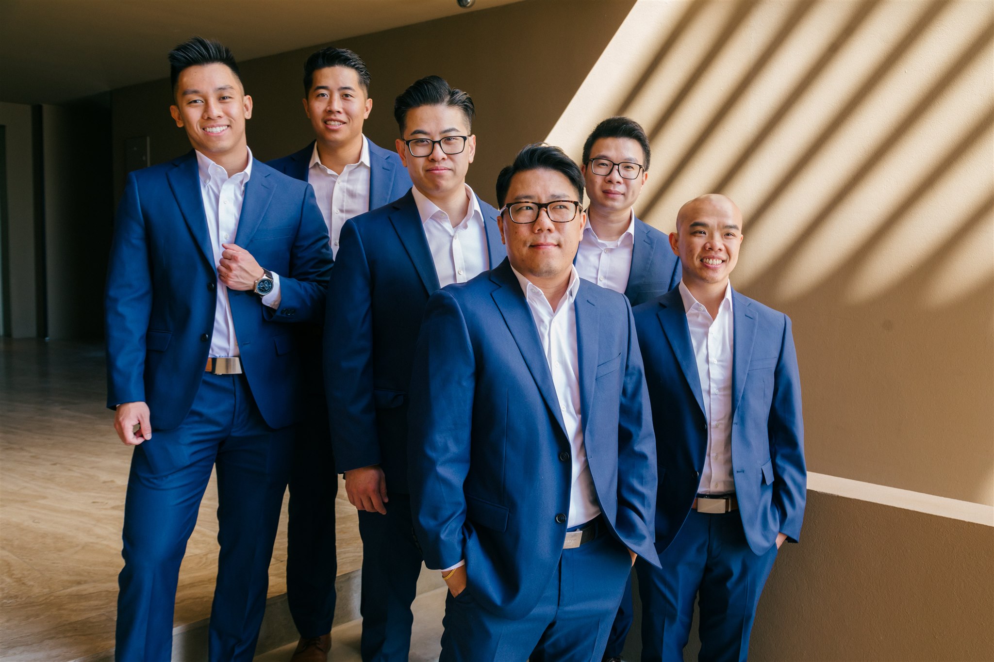 groomsmen pose for a photo together