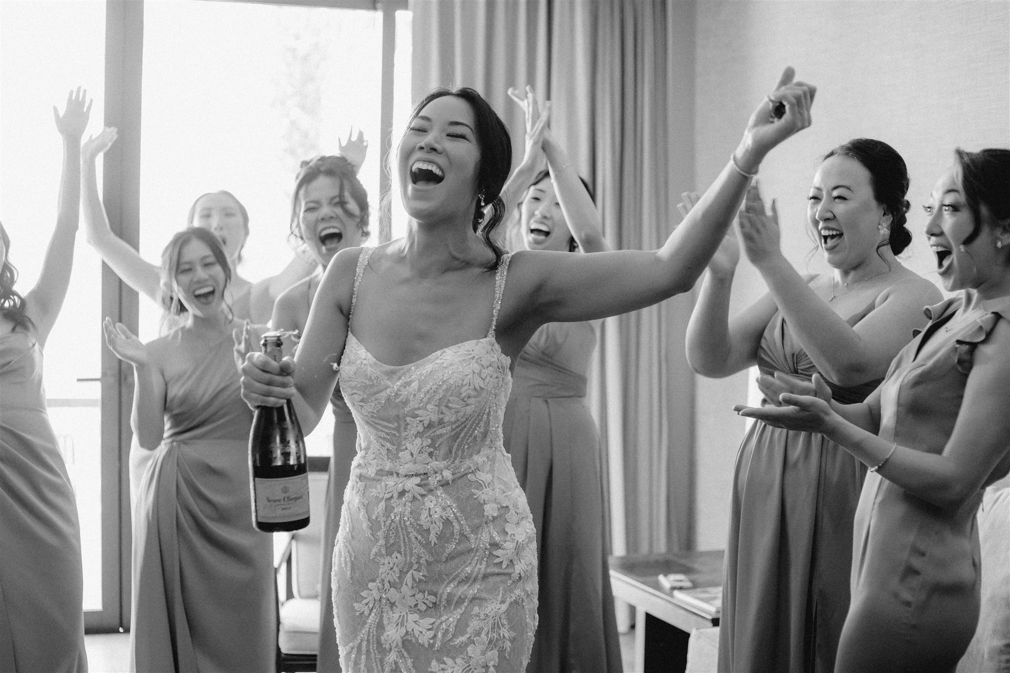 bride celebrates with her bridal party 