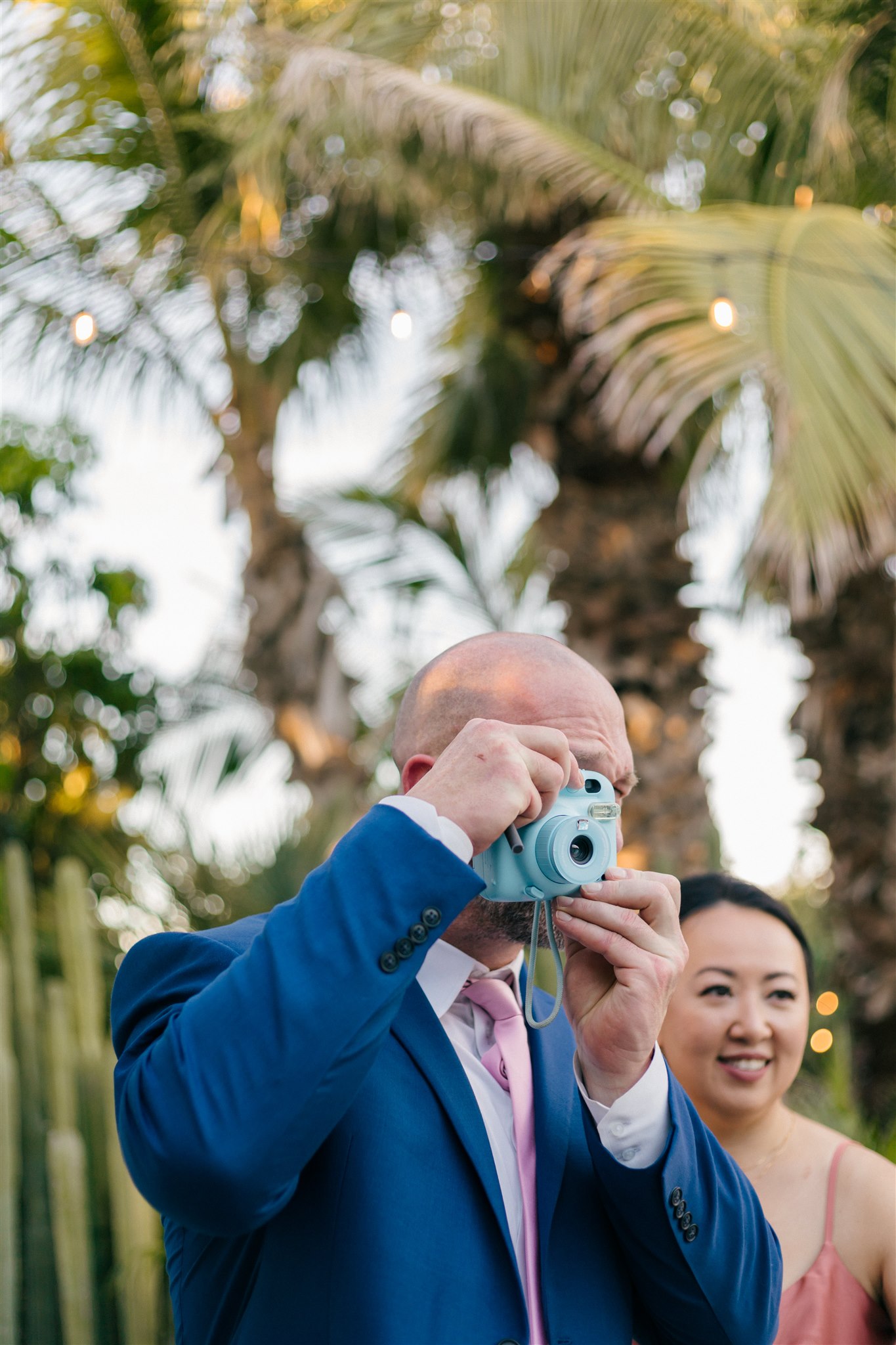 guest snaps a photo on a polaroid