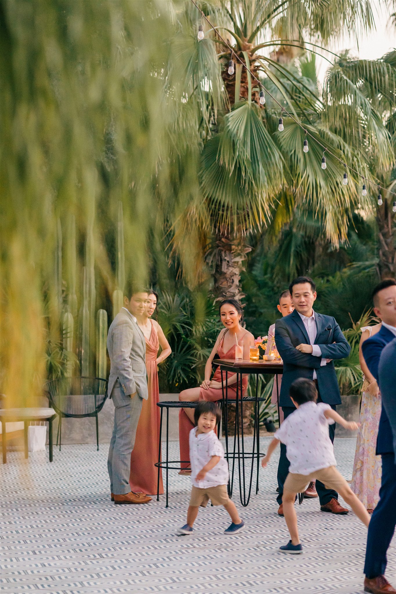 guests watch as children play during the tropical cocktail hour