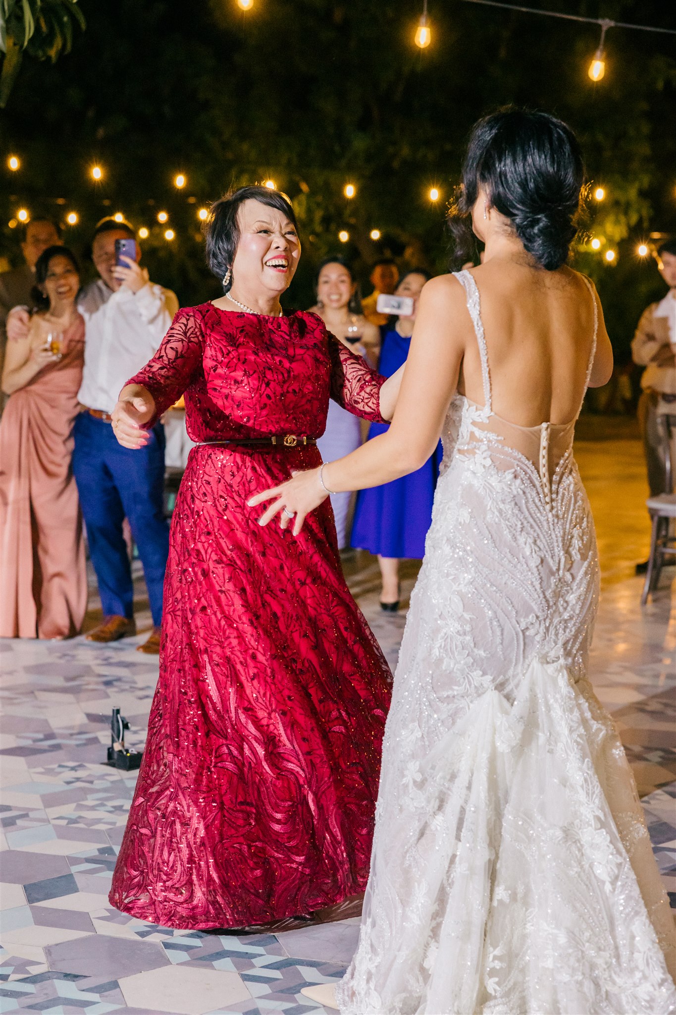 bride and her mom dance during her stunning tropical wedding reception