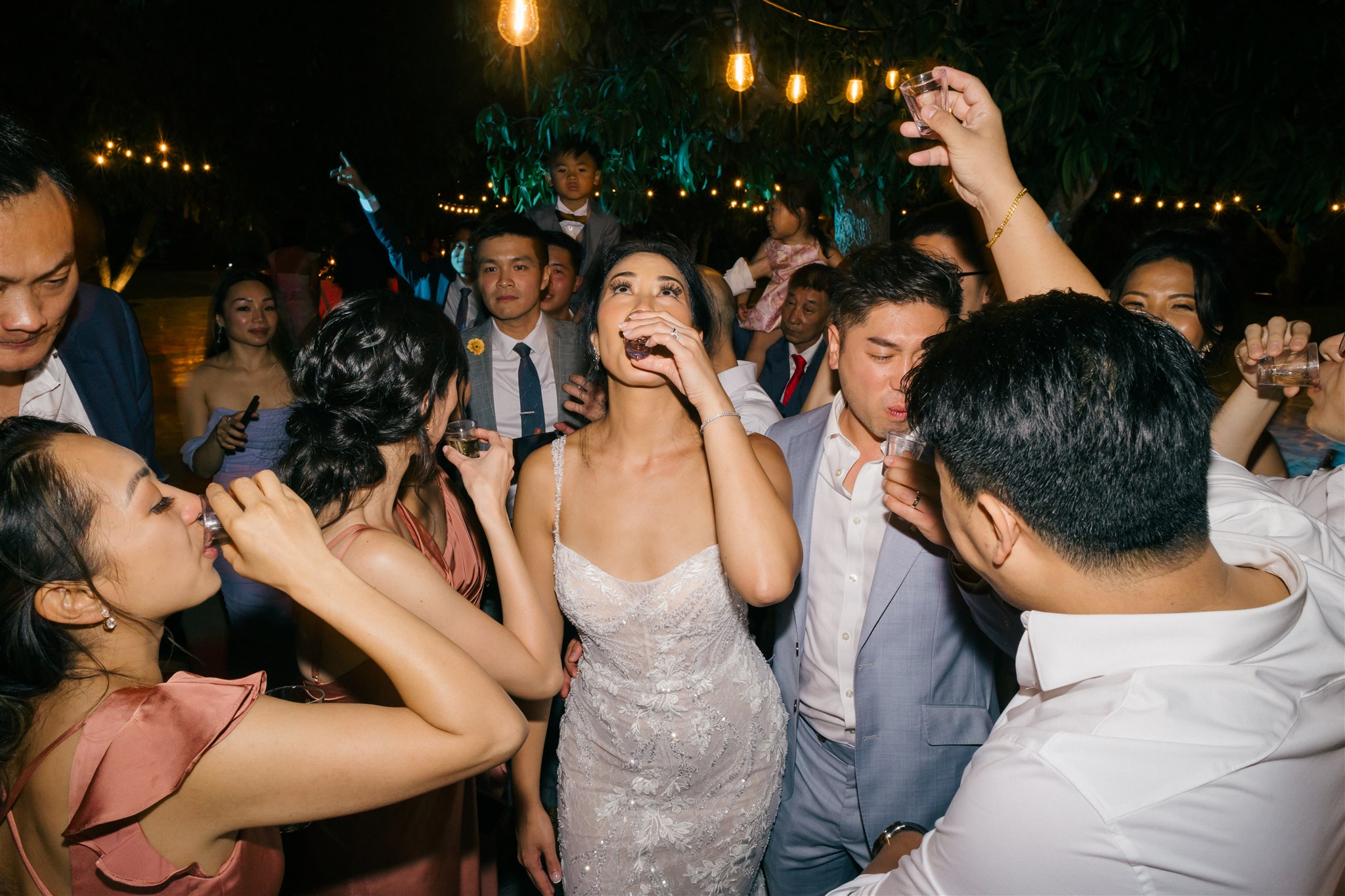 bride and groom celebrate with their guests during the tropical wedding reception