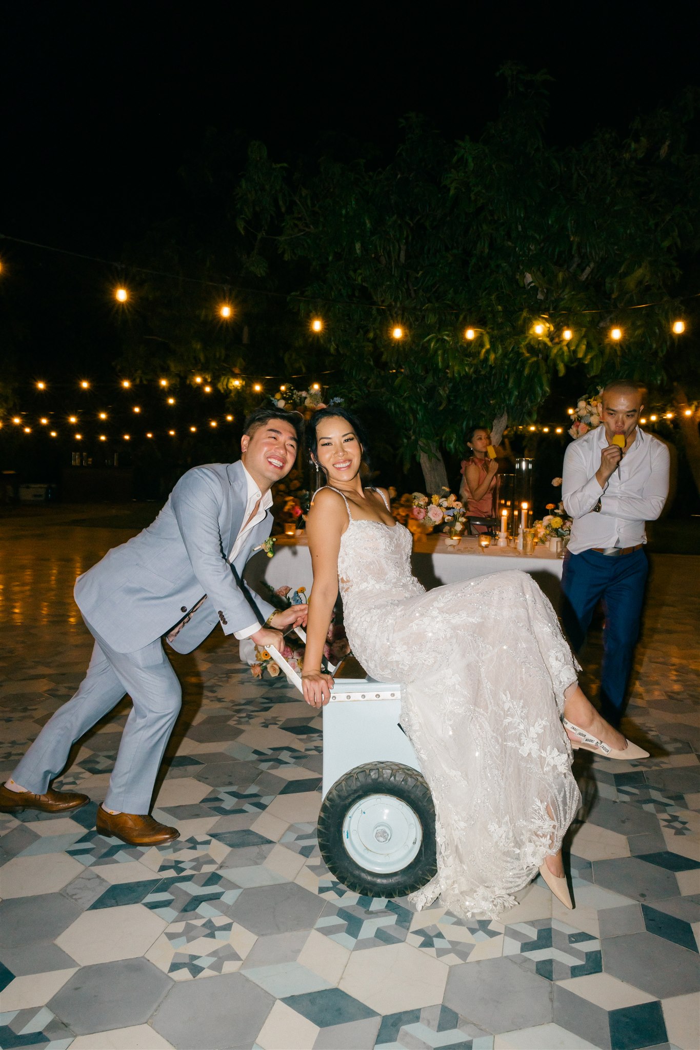 bride and groom take a candid photo during their acre baja wedding reception