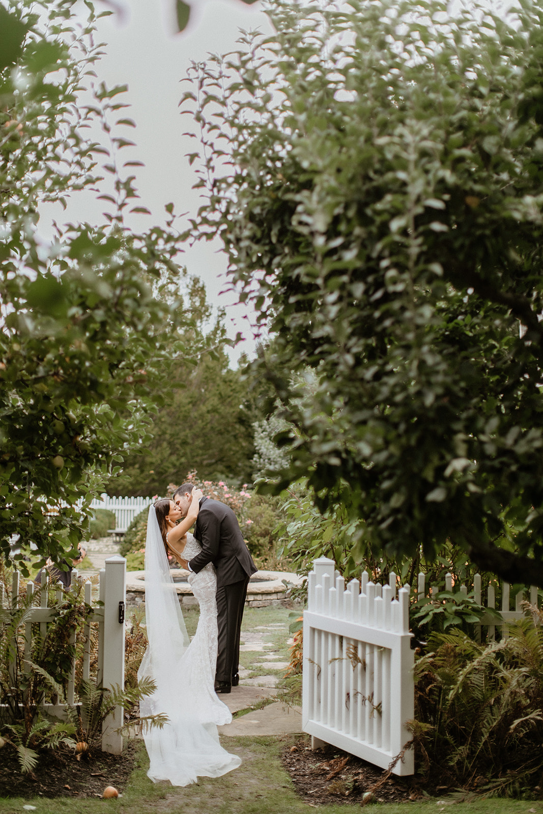 gorgeous bride and groom pose together after their vineyard wedding on long island