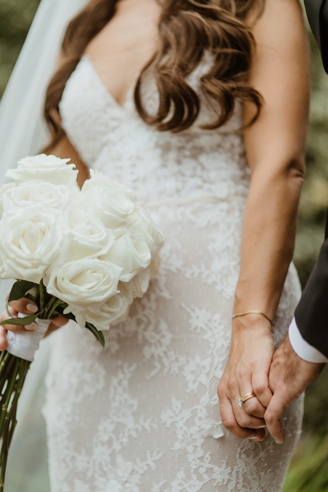 bride and groom hold hands as the mingle on their wedding day