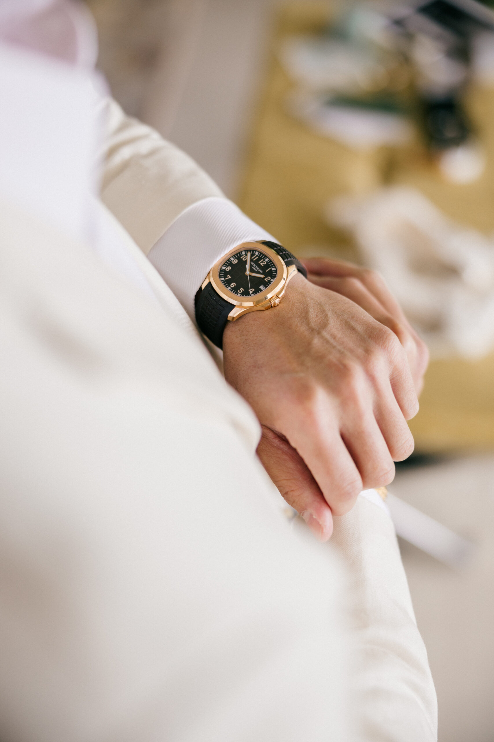 groom checks his watch before he heads to his Cancun wedding