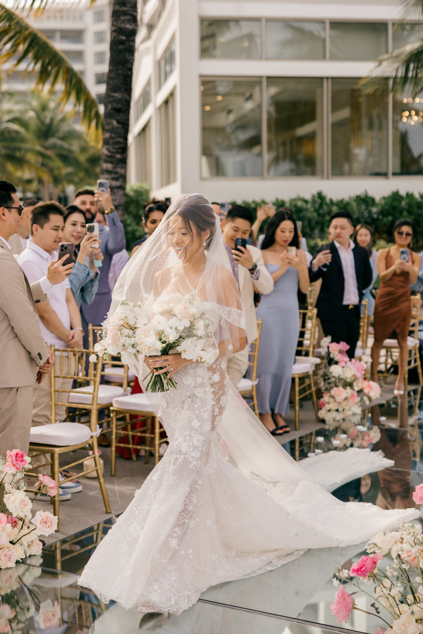 beautiful bride enters her dreamy tropical wedding ceremony