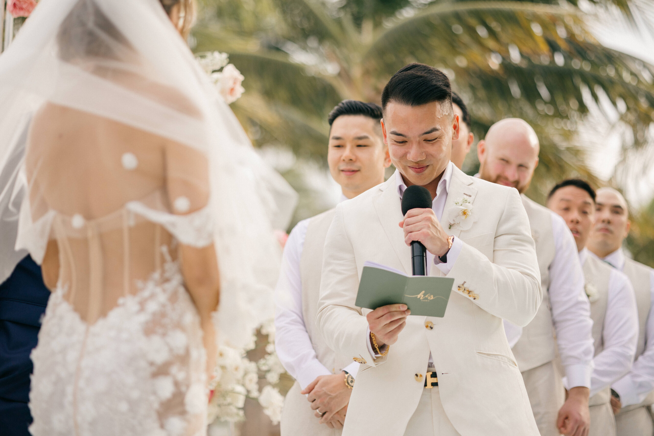 groom reads his vows at his tropical Cancun wedding