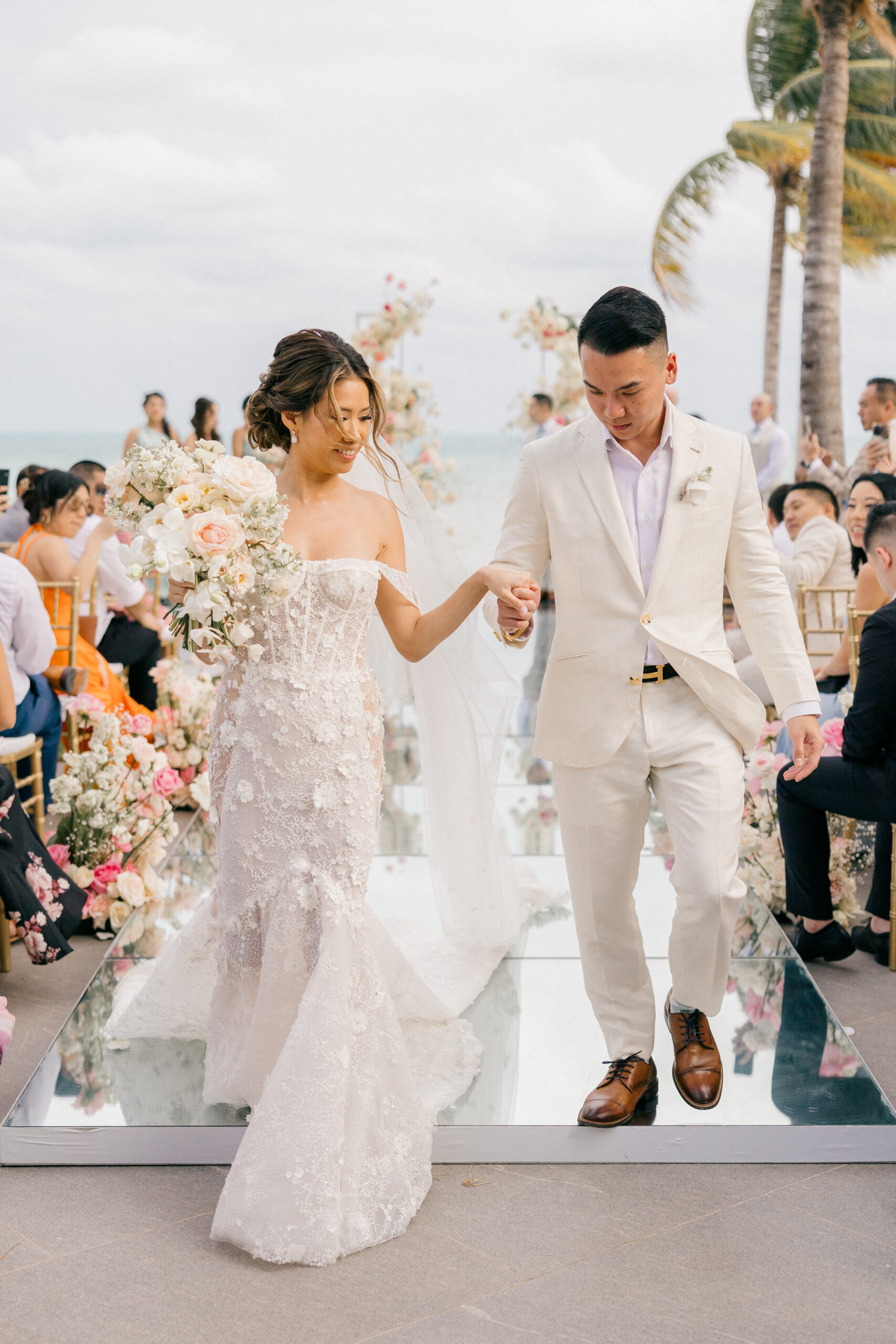 bride and groom exit their elegant Cancun wedding ceremony