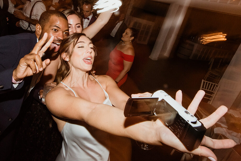 guests celebrate with the bride and groom during the elegant winery wedding reception