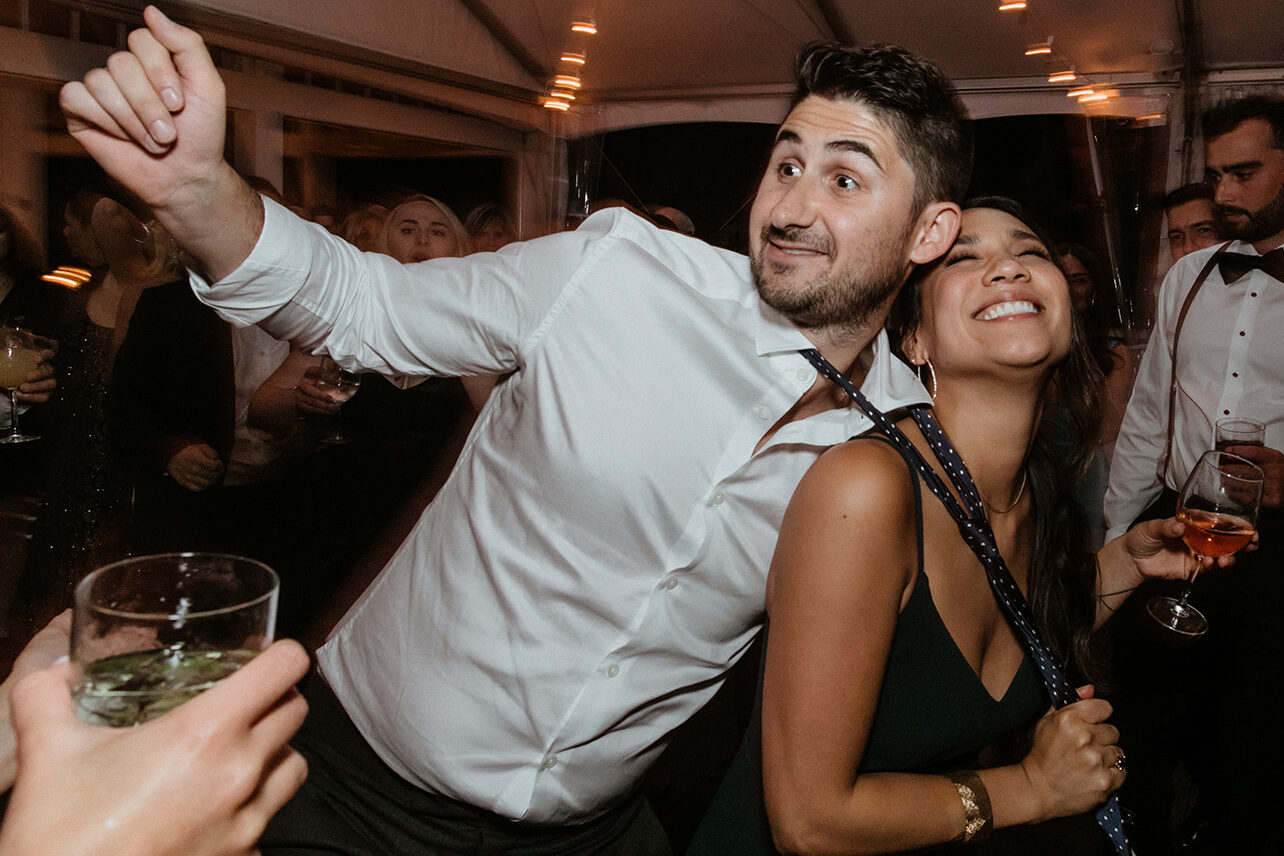 guests celebrate with the bride and groom during the vineyard wedding reception on long island