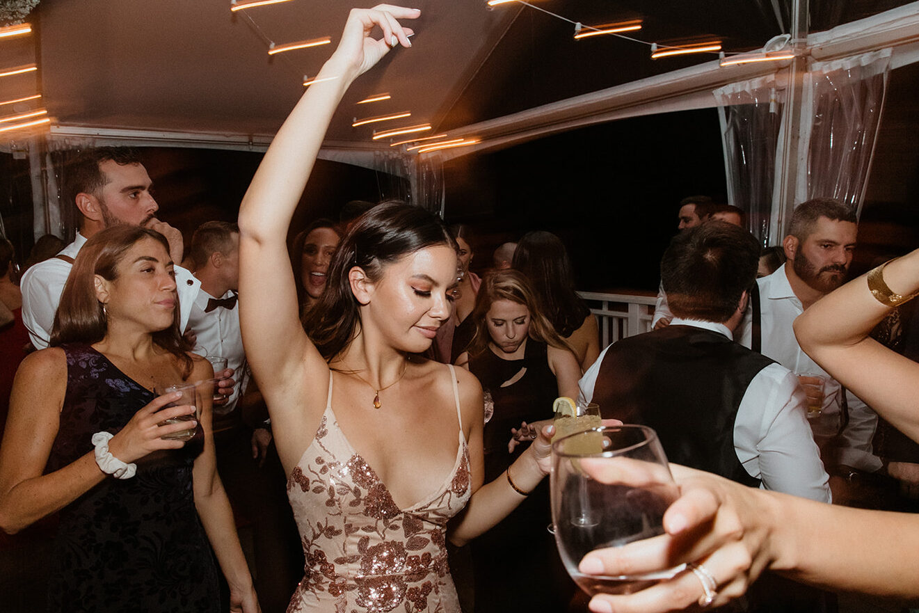 guests celebrate with the bride and groom during the elegant winery wedding reception