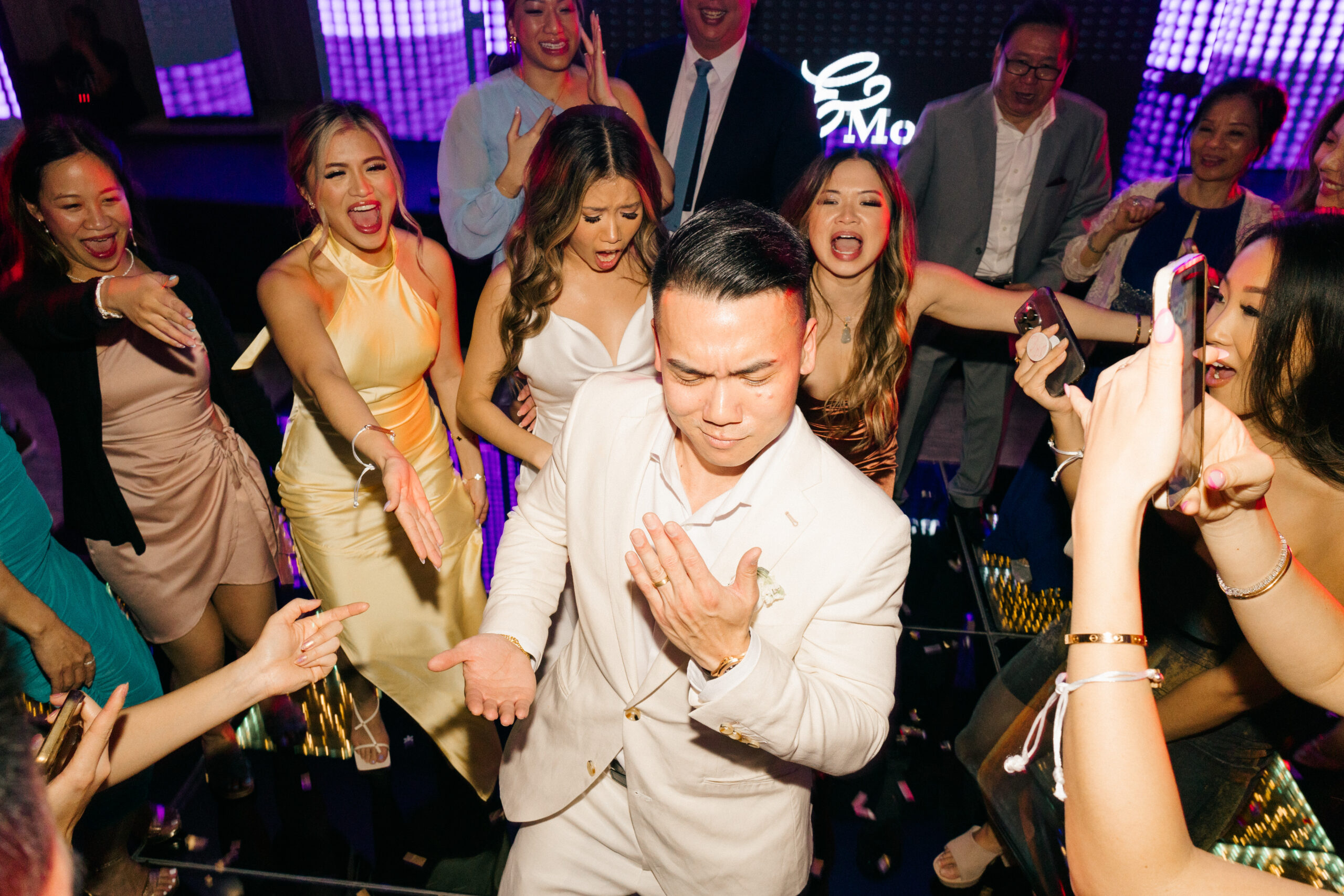 guests celebrate on the dance floor with the bride and groom