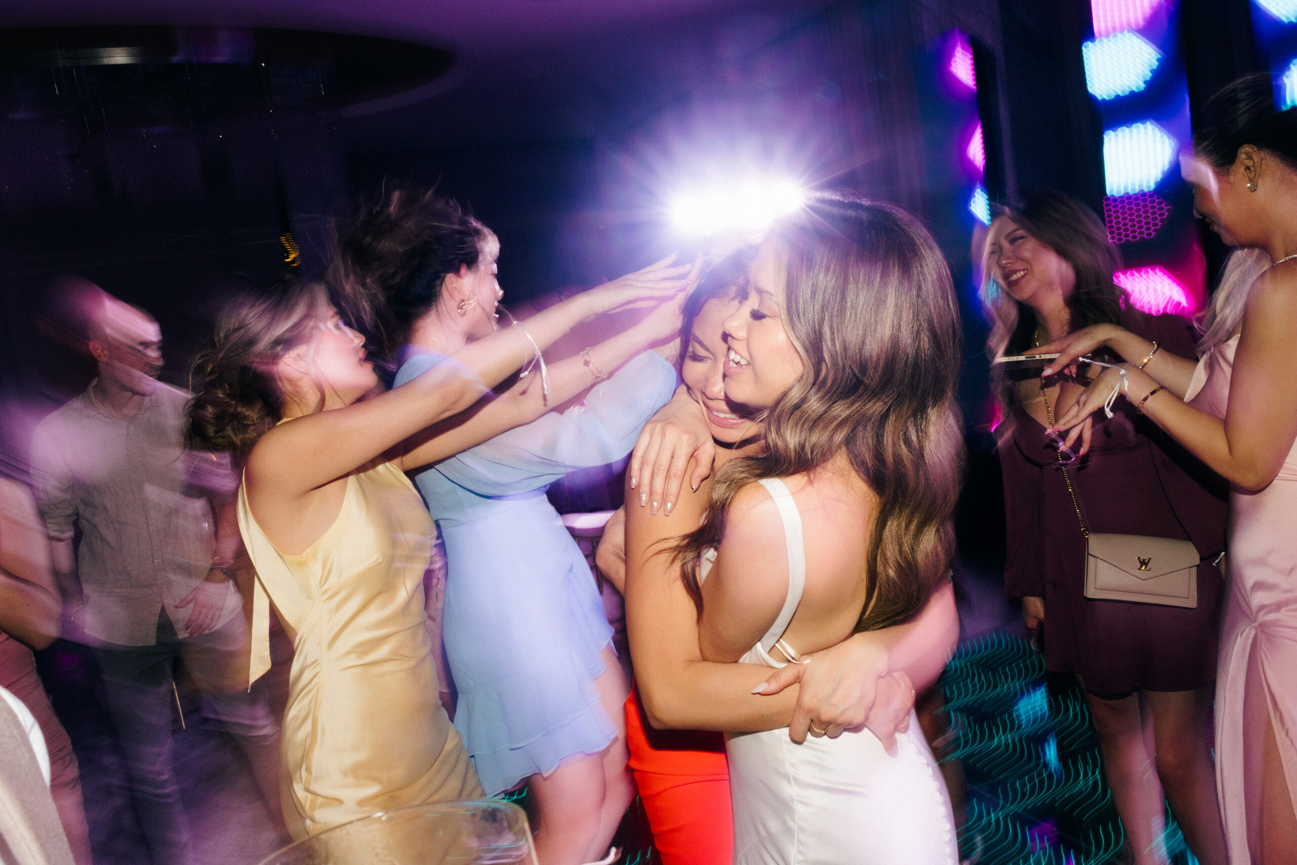 guests celebrate on the dance floor with the bride and groom