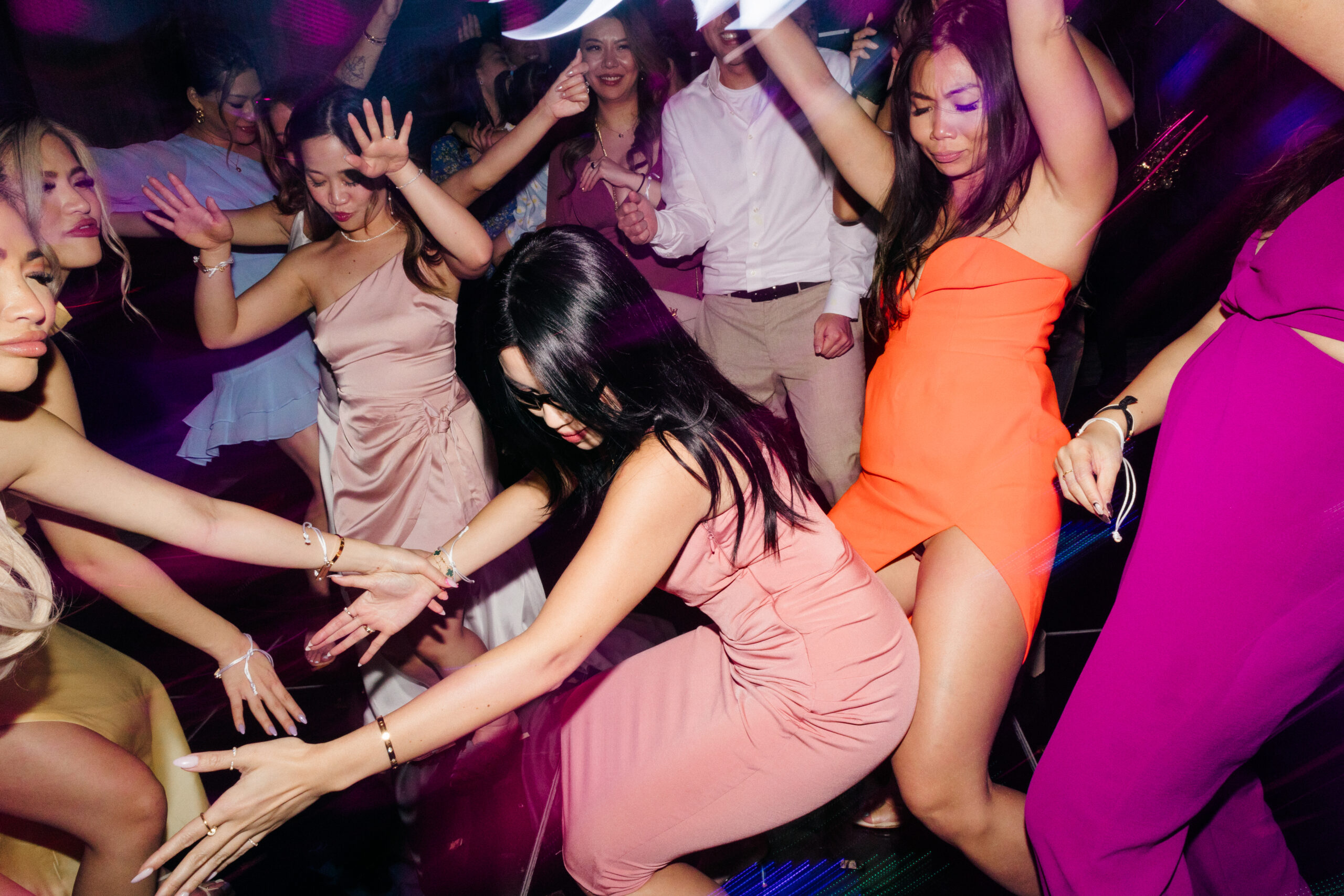 guests celebrate on the dance floor with the bride and groom