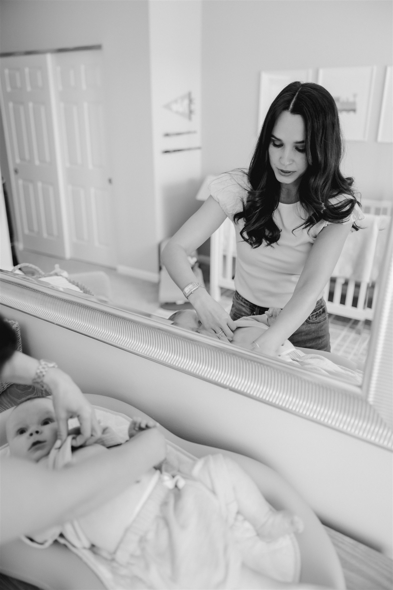 new mom takes care of her newborn during their in-home newborn sessions