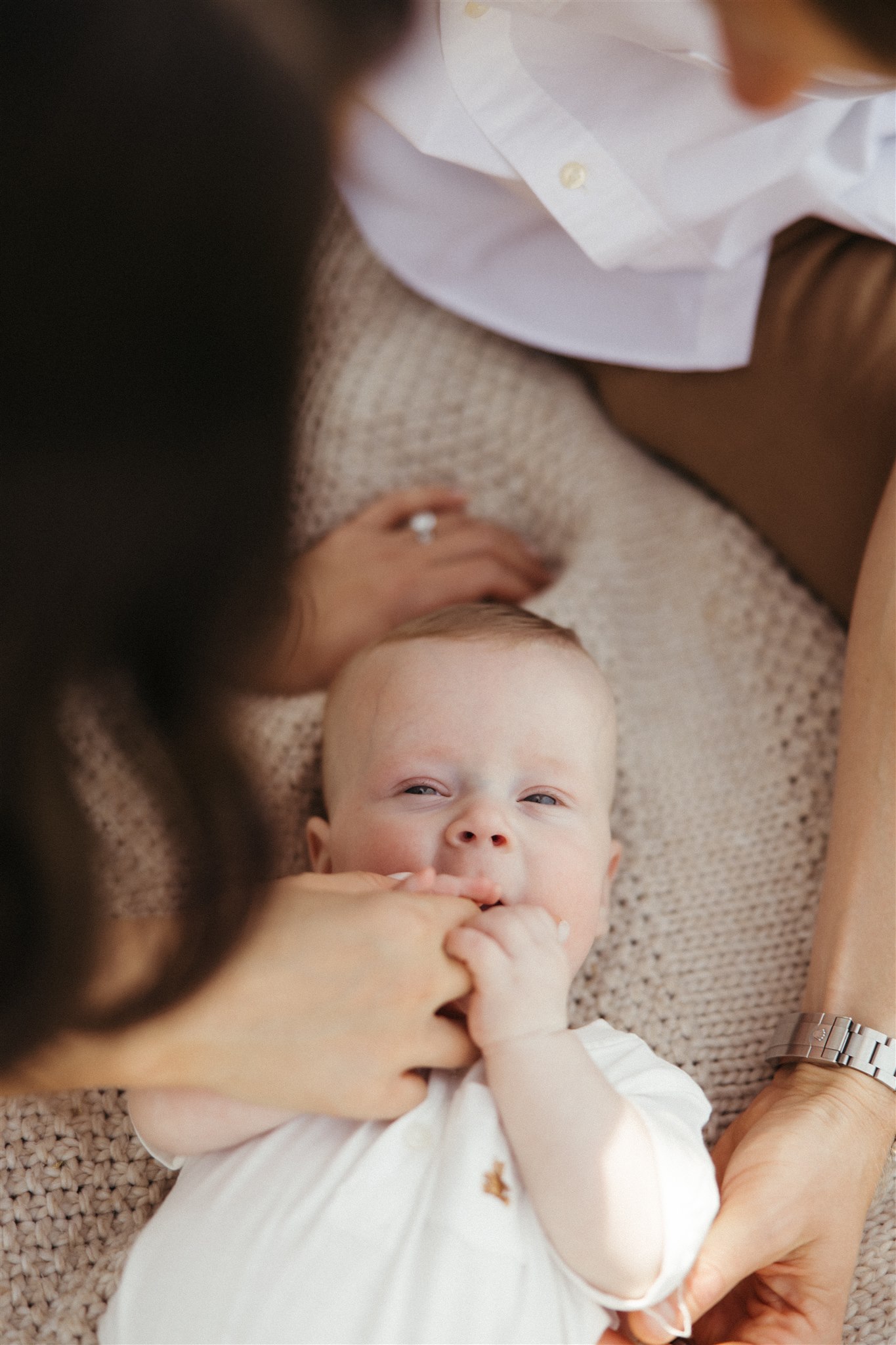 new mom poses with her newborn during their in home family photo session