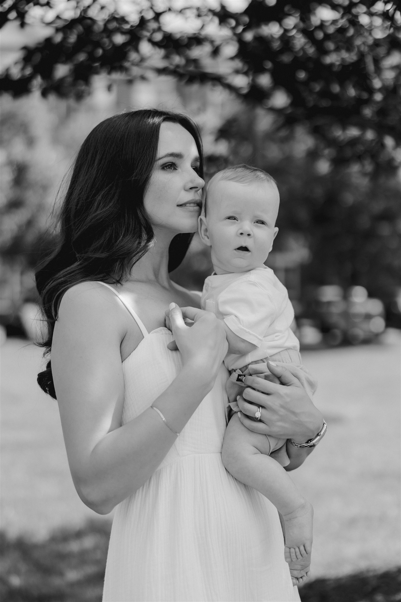 new mom poses with her newborn during their in-home newborn sessions