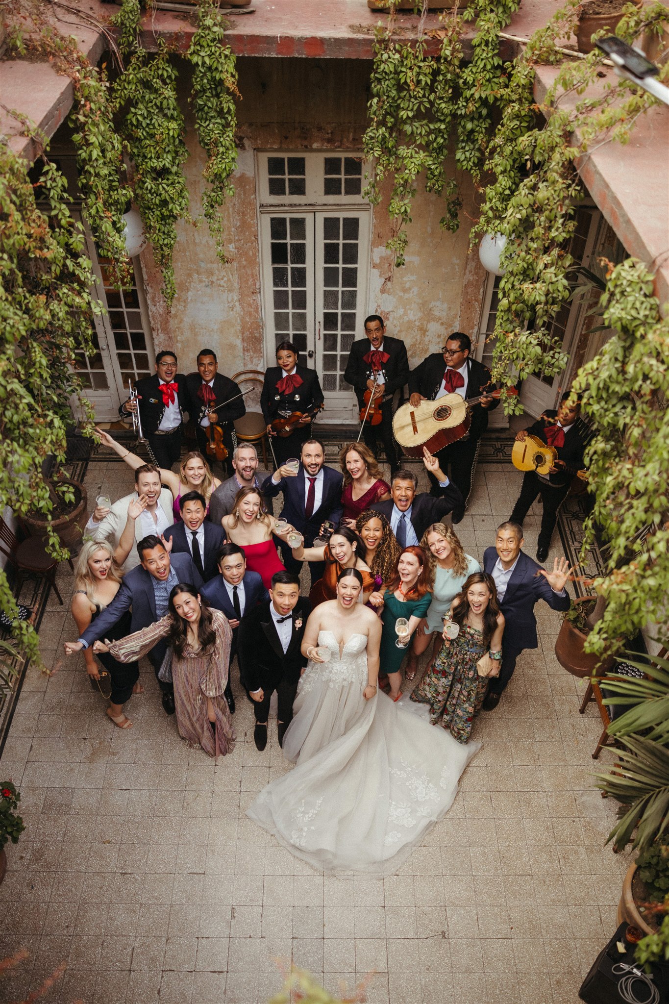 wedding party and guests pose together for a photo together
