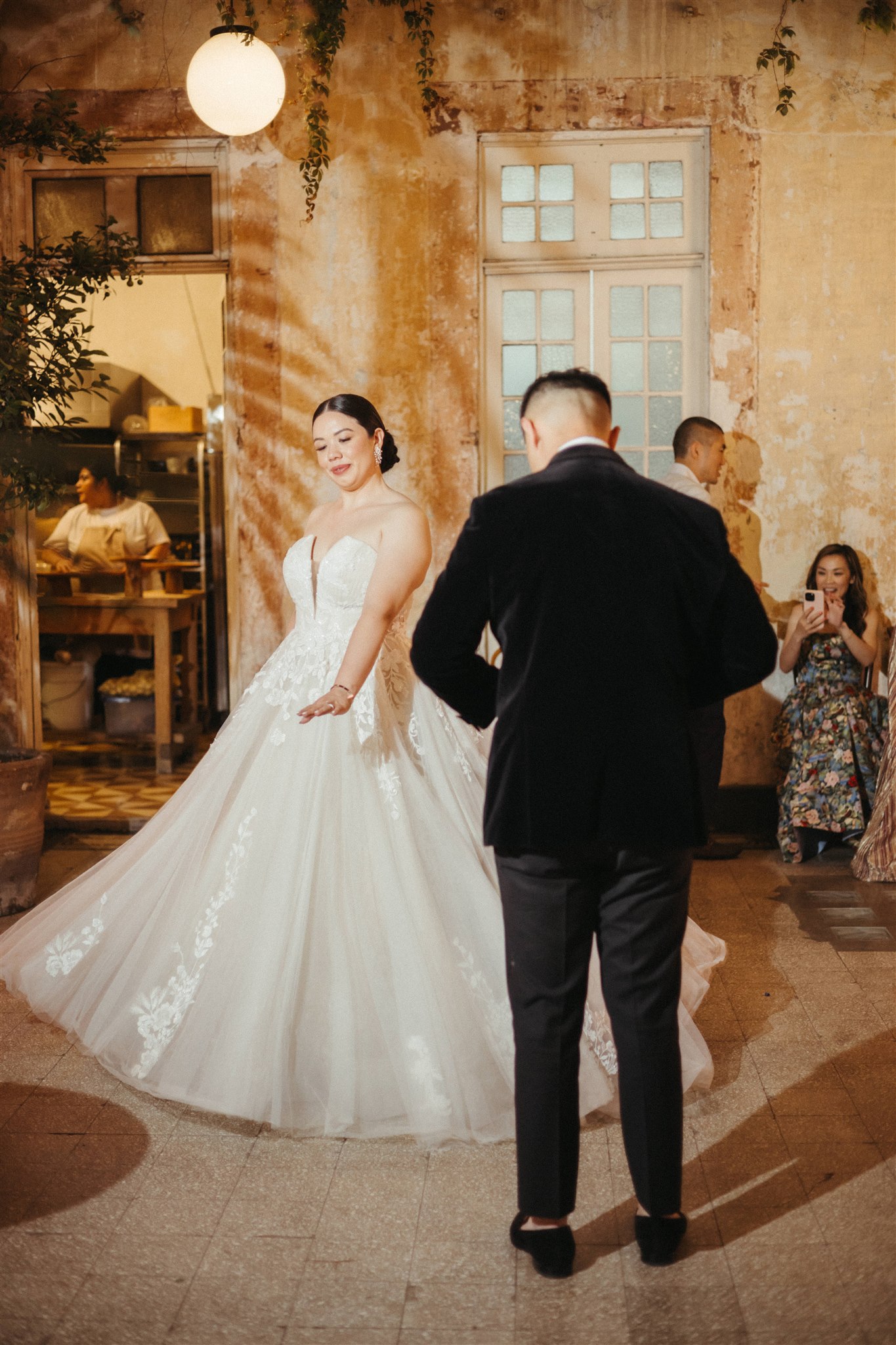 Bride twirling in courtyard during lively evening reception
